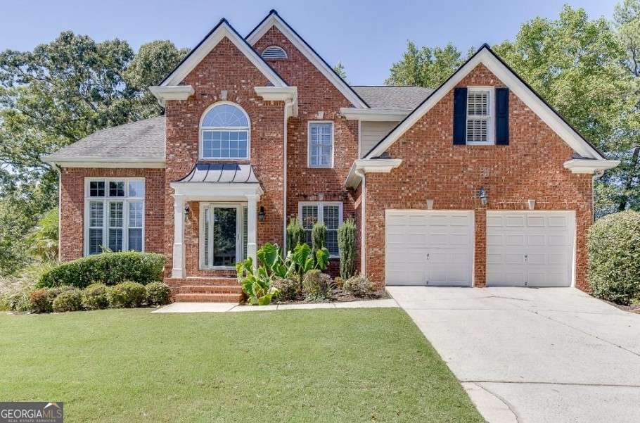 Welcome to this stately 4-bedroom, 4-bath traditional home, recently enhanced with several updates this year, including new white oak floors on the main. A grand two-story foyer opens to a formal dining room, home office with custom built-ins, and a fireside family room that flows into a bright kitchen with Carrera marble countertops, marble backsplash, stainless appliances, and access to a large deck. The main level offers a guest suite, while upstairs the oversized primary retreat includes a sitting area, dual walk-in closets, and a spa-like bath. Two bedrooms share a Jack-and-Jill bath, and the upstairs laundry adds convenience. The finished terrace level provides a second office/craft room, rec room with wet bar, full bath, and walk-out to a covered deck. Outside, enjoy a private backyard oasis with a solar-heated saltwater pool, 15 palm trees, and low-maintenance turf-your year-round retreat at home.