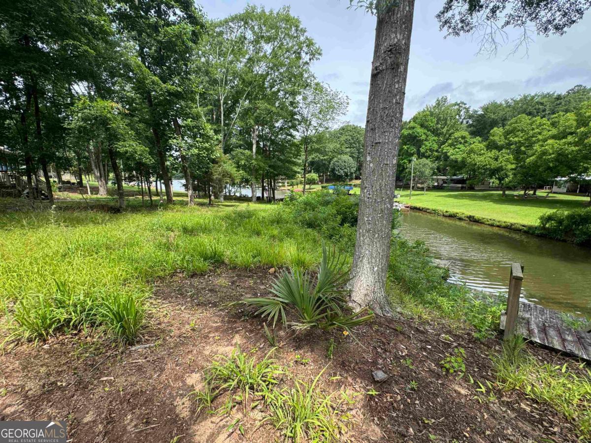 This beautiful property is on Lake Oconee! It offers about 122 ft of water frontage and a dock for boat access. The world is your oyster on this land. Conveniently located near Long Shoals Marina. Being sold "as is". Mobile home is inhabitable and would need to be removed by new owner.
