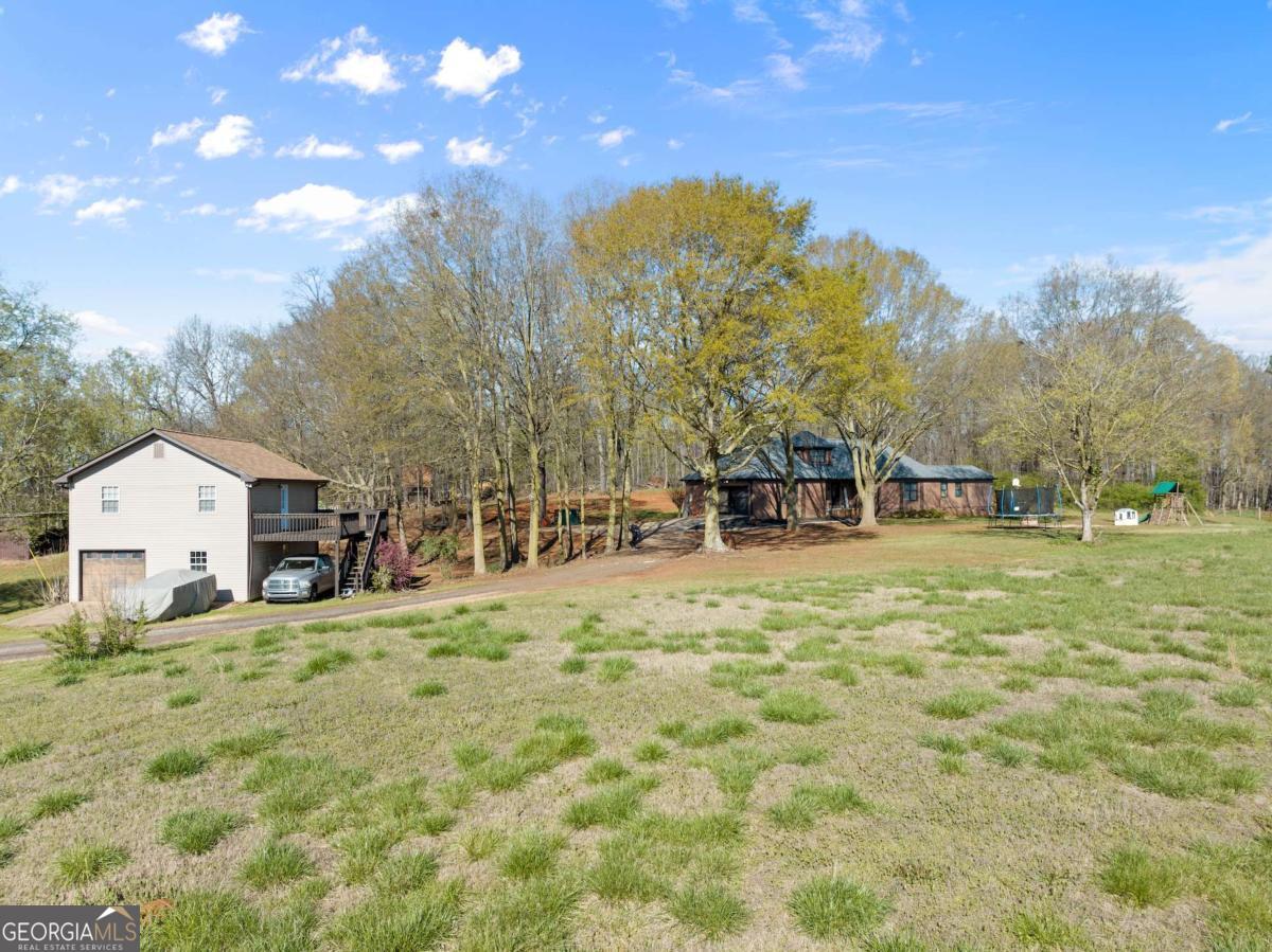 2 houses on gated 11+ acres, both houses meticulously maintained. 2 new roofs, a new HVAC system, main house newly painted indoors and outdoors, all new decks. House has 2 master bedrooms, 2 large bedrooms upstairs for a total of 4 rooms, additionally garage has been finished with central heating and air for an office space, gym, homeschool room, etc. Large area in the back yard, a side pasture, and a large pasture in the front for animals or having fun! Endless opportunities. MORE PICTURES COMING! Backyard has been cleared and seeded with grass, with a above ground and new large deck.