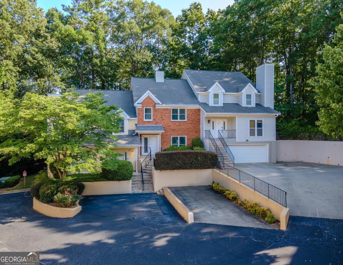 Welcome to this beautifully renovated townhome located in the heart of Sandy Springs. This home has been completely updated from top to bottom with modern finishes and smart design. You'll love the brand-new flooring throughout the main and upper levels, fresh paint, stylish light fixtures, and sleek hardware. The kitchen features stainless steel appliances, granite countertops, subway tile backsplash, and crisp white cabinetry-perfect for anyone who enjoys cooking or entertaining. The open-concept living room includes built-ins and a painted double sided brick fireplace that adds character and warmth. French doors off the dining area lead to a private patio, ideal for morning coffee or evening wine. Upstairs, both bedrooms are generously sized with great closet space. The bathrooms have been tastefully remodeled with new vanities, lighting, and fixtures. The oversized owner's suite features tray ceilings and an en suite bath with updated fixtures and tile. This unit offers the ultimate in convenience and lifestyle-just minutes to shopping, dining, and all that Sandy Springs and the Perimeter area have to offer. Easy access to GA-400 and I-285 makes commuting a breeze. Perfect for first-time buyers, downsizers, or savvy investors. No renovation headaches here-this one is done and ready for you!