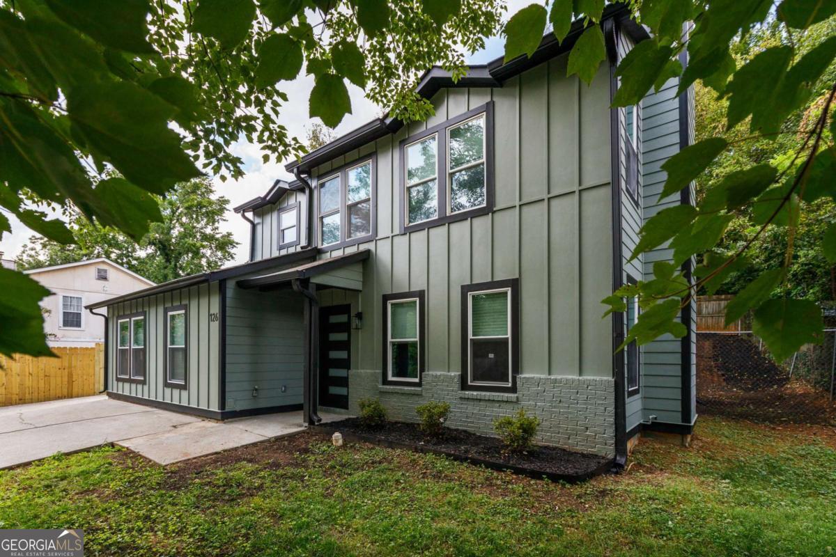 This East Atlanta showstopper has everything buyers are looking for: bold design, thoughtful upgrades, and serious flexibility. Tucked in one of the city's most desirable neighborhoods, this fully renovated contemporary home offers four bedrooms, three and a half baths, and two primary suites-ideal for guests, roommates, or multigenerational living. Step inside to rich oak hardwoods, soaring ceilings, and an open layout that's bathed in natural light. A dramatic wall of windows frames the living room, anchored by a sleek fireplace and flowing into a spacious dining area and fenced backyard-complete with a patio perfect for grilling or sipping coffee under the trees. The chef's kitchen stuns with modern wood-grain cabinetry, quartz counters, designer backsplash, and a five-burner gas range-ready for your next dinner party or casual weeknight in. The main level also includes a guest bath, newly added laundry room, and the first of two luxurious primary suites with a spa-like ensuite bath. Upstairs, you'll find two bright guest rooms, a beautifully updated hall bath, and the second primary suite featuring a walk-in closet and private bath. Major upgrades include all-new siding, windows, electrical, plumbing, HVAC, and fresh paint-inside and out. Location is KEY: just minutes from East Atlanta Village, the Beltline, and Edgewood Retail, with seamless access to Midtown, Decatur, Emory, and major interstates-this home puts the best of Atlanta right at your doorstep. The seller is extremely motivated, so if you're looking for an incredible value, this is it!