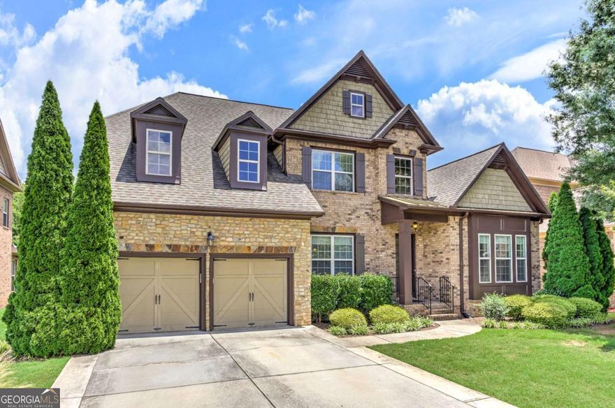 Beautiful 3-sided traditional brick home located in desirable Jamerson Estates.  10+ ft. ceiling, detailed crown molding, a massive open floor plan, hardwood floors make this spacious home a truly functional home.  As you walk into the main foyer of the home you have a formal living room/home office area, and a large formal dining area perfect for entertaining and hosting a large group. The main level has an owner's suite with a whirlpool bath, separate shower, double sinks, and a spacious walk-in closet.  An additional ensuite bedroom with a private full bathroom is conveniently located on the main level of the home.  2 bedrooms on the main level make this a very unique feature of the home's layout.  The kitchen is large with stainless steel appliances, gas range, double ovens, a large island with an eat in kitchen area that overlooks the deck and backyard.  The kitchen opens to the large family room with a gas fireplace and a stereo system.  Off of the garage is a mud room which opens to a laundry room.  The upstairs offers two additional bedrooms with a jack and jill bathroom, and a large loft area, ideal for a sitting room, play area, or flex space let your imagination make this space the best use for your use.  The full basement includes two oversized workshop/storage areas that can easily be converted into additional bedrooms, offices, or living space. A large bedroom with a full bath is located in the basement, offering potential for a full in-law suite conversion. Enjoy outdoor living with a level lot, upper deck, and a second deck off the basement level, perfect for entertaining. Located in a quiet, established neighborhood with a walking trail, top-rated schools, and easy access to shopping, dining, and parks.  Close to I-575, and Hwy 92 with easy access to GA400.  Take the time to see the possibilities this home will offer you.