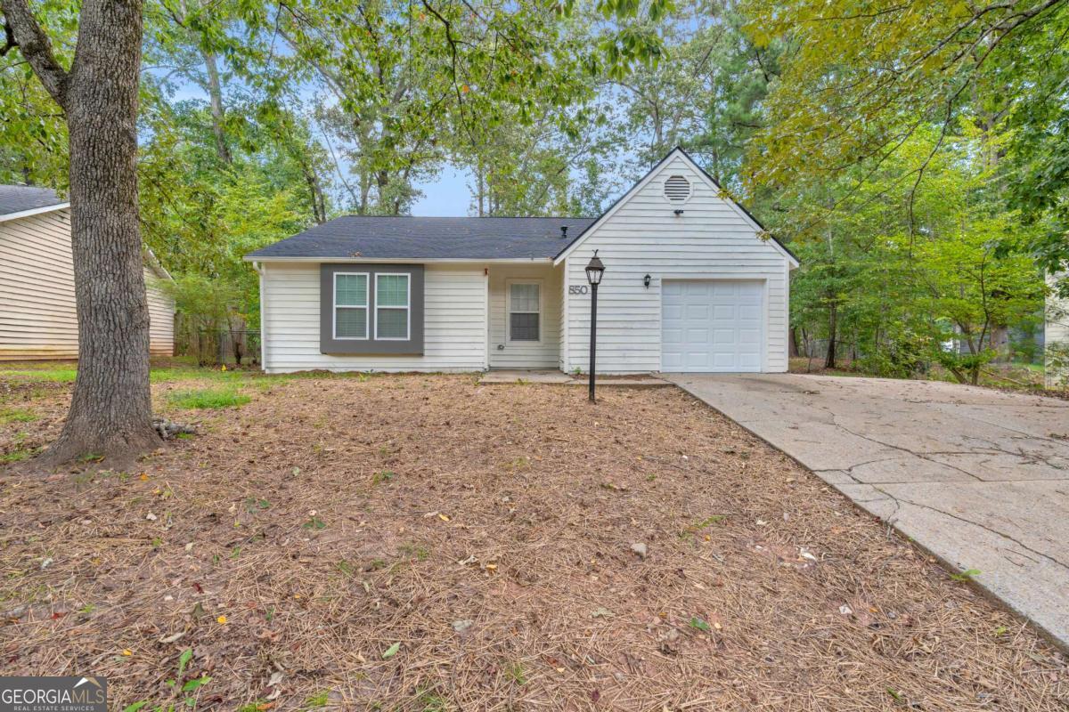Welcome to Your Dream Home in Stone Mountain! Step into this stunning, fully renovated ranch-style home nestled in the heart of the charming and historic Stone Mountain community. Thoughtfully redesigned from top to bottom, inside and out, this home combines modern finishes with timeless charm-offering all the comforts of new construction without the premium price tag. As you enter, you're immediately welcomed by a custom-built electric fireplace, beautifully framed by a floor-to-ceiling accent wall that adds warmth and style to the living space. The open-concept floor plan seamlessly connects the living, dining, and kitchen areas, creating the perfect layout for entertaining and everyday living. The kitchen is a true showstopper-completely custom-built and designed for both beauty and functionality. Featuring striking granite countertops, a floor-to-ceiling tile backsplash, and a large breakfast island at the center, this space is surrounded by sleek, soft-close white cabinetry that offers ample storage for all your culinary needs. The living room boasts brand-new flooring, soaring ceilings, and recessed lighting that enhances the spacious feel while providing a bright, inviting atmosphere. Just down the hall, you'll find three generously sized bedrooms, each with brand-new carpet, updated windows, and stylish lighting fixtures. Both bathrooms have been fully updated with modern finishes and thoughtful design. The master suite features soaring arched ceilings, a custom tiled walk-in shower, and dual closets-perfect for a his-and-hers setup. Outside, enjoy a large, level backyard ideal for outdoor gatherings, gardening, or simply relaxing in your private oasis. Located in a quiet, established neighborhood with easy access to major highways, shopping, and dining-this home truly offers the best of both comfort and convenience. Don't miss the opportunity to make this beautifully remodeled home yours! Schedule your private tour today and experience the perfect blend of style, function, and value. This one won't last long!