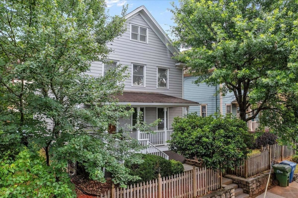 Nestled at the northern edge of Grant Park near Cabbagetown, this 3-story city home offers single family living surrounded by city amenities only footsteps away. Ascend to your welcoming front porch perched above a quiet one-way street. Upon entry the foyer presents a stair to upper floors and access to living spaces. The living room flows into dining which opens to a family room/kitchen space.The kitchen features granite countertops, stainless steel appliances and an island bar that focuses on the opposing feature wall with a gas log fireplace, built-in bookcases and plenty of sunshine. On the second follow the hardwood path to the Owners Suite offering a En-suite Bath and walk-in closet with custom shelving units. Two sunny Guest Bedrooms share a full bath at end of the hallway. Finally a Second Stair rises to the Third level offering the Bonus optional 4th Bedroom/Studio or Playroom. Your new home is 3 blocks from the Eastside BeltLine, and adjacent to bars, restaurants & shopsG??.right where you want to be!