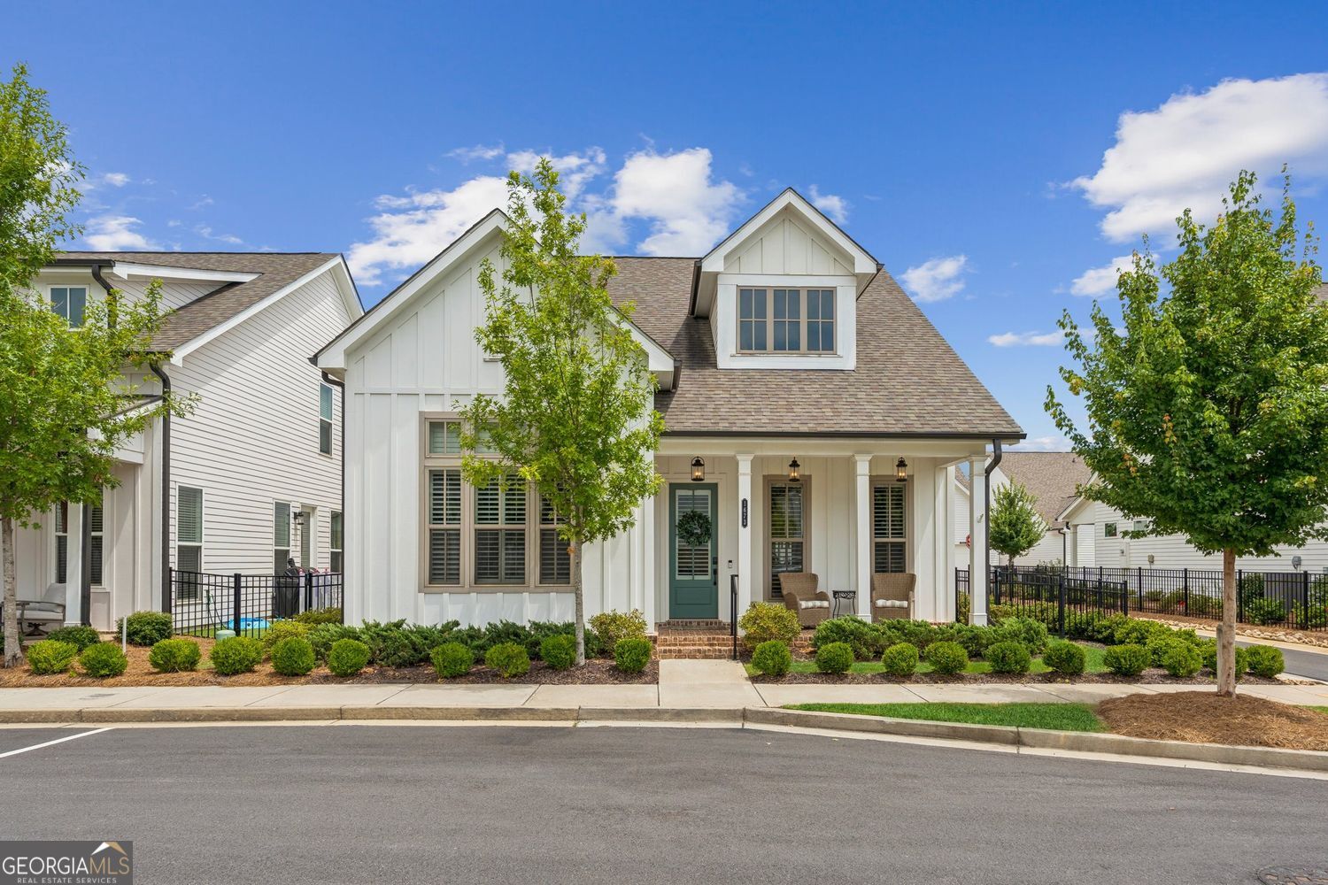 Welcome to the "Harrison A" - an open floorplan that perfectly blends sleek design with effortless living, just minutes from Suwanee Town Center and the Greenway. Start your day on the inviting front porch, the ideal spot for morning coffee or evening wine. Inside, you'll find luxury LVP floors and elegant crown and baseboard molding that add a polished, high-end touch. Plantation shutters fill the space with natural light while offering timeless charm. The living room is a showstopper - complete with a modern shiplap feature wall and a cozy gas fireplace you can control with the flip of a switch or remote. Recessed lighting sets the mood for relaxing nights or lively gatherings. The kitchen is pure culinary eye candy, anchored by a show-stopping "Fantasy Brown" marble island and countertops. The oversized center island seats four, making it the perfect gathering spot while entertaining. Stainless steel Whirlpool appliances - including a Smart WiFi 5-burner gas range, microwave, and vent hood - elevate this kitchen for both everyday cooking and gourmet meals. White shaker cabinets with under-cabinet lighting brighten your workspace, while a decorative subway tile backsplash adds just the right pop of style. A smartly designed pantry is seamlessly tucked within the cabinetry, and yes - the refrigerator is included! Just off the kitchen, you will find a dedicated dining room that sets the stage for everything from cozy dinners to lively gatherings. Sliding glass doors open to a covered porch, featuring upgraded beadboard ceiling and a cooling ceiling fan - the perfect spot for unwinding after a long day. The fenced backyard defines the space beautifully and adds a polished touch to the outdoor living area, creating your own outdoor retreat. The Owner's Suite is located on the main level and is a luxurious retreat, boasting high 12' ceilings that create an expansive feel. The primary ensuite offers a spa-like experience with its "super shower," a double vanity with extra drawer space, and a generous walk-in closet, providing plenty of storage. Upstairs, two large secondary bedrooms await, perfect for family or guests. They share a well-appointed upper-level bath with a convenient double vanity. Need more storage? A spacious unfinished walk-in attic offers incredible potential for all your belongings. Enjoy Modern conveniences at your fingertips with a laundry room featuring a smart Samsung washer & dryer to remain, and built-in cabinets. 2-car garage featuring a smart garage door, a Ring alarm system (unmonitored) included, and a Schlage Wifi Deadbolt on the front door. Imagine a life where your weekends are truly yours, thanks to HOA-provided lawn maintenance, leaving you free to enjoy the best of community living at your community pool, firepit, parks, walking trails, play area, and clubhouse.