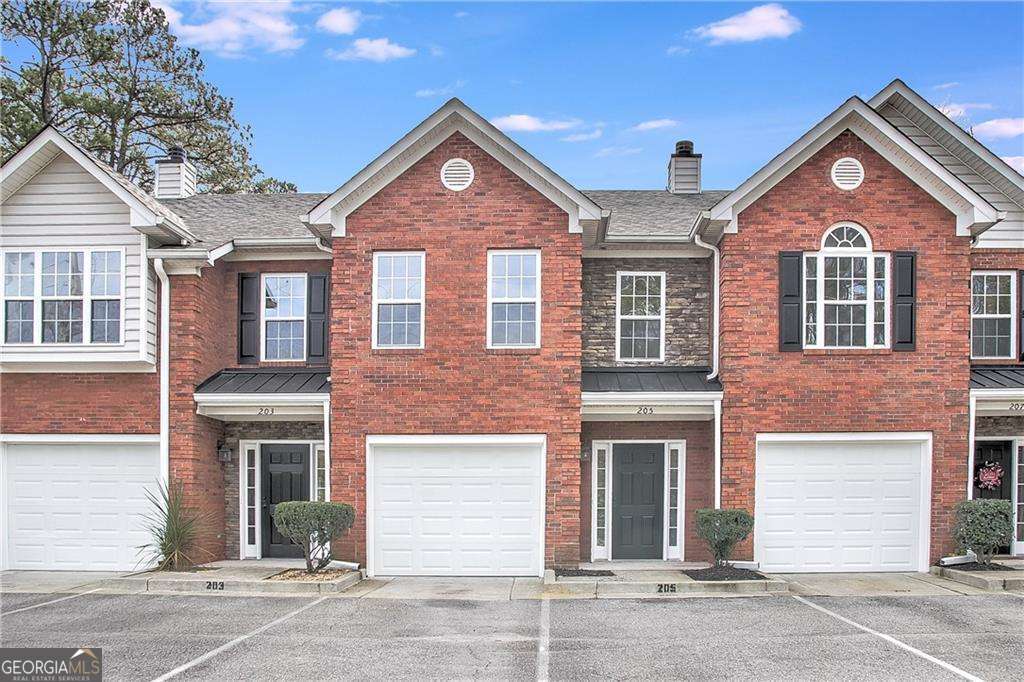 This beautiful renovated townhome offers all new luxury vinyl/laminate flooring throughout both levels, new interior paint, all new stainless steel appliances, beautiful granite countertops in kitchen and baths, new faucets, new light fixtures / ceiling fans, gorgeous large walk in shower with beautiful glass doors. Main level offers entry foyer, white kitchen with deep breakfast bar that feels more like an island, stainless steel under-mount sink, kitchen opens to family room with brick fireplace and dining area. Glass door opens out to your fenced backyard with concrete patio and large lawn area, fully fenced. Oversized primary bedroom upstairs with big walk-in shower, along with large secondary/2nd primary bedroom with tub/shower combo and huge closet. Townhouse has a single car garage, there are also 2 assigned parking spaces directly in front of the unit along with guest parking. Minutes to Downtown Woodstock, Roswell and Alpharetta. Close to Highway 92 and Interstate 75.
