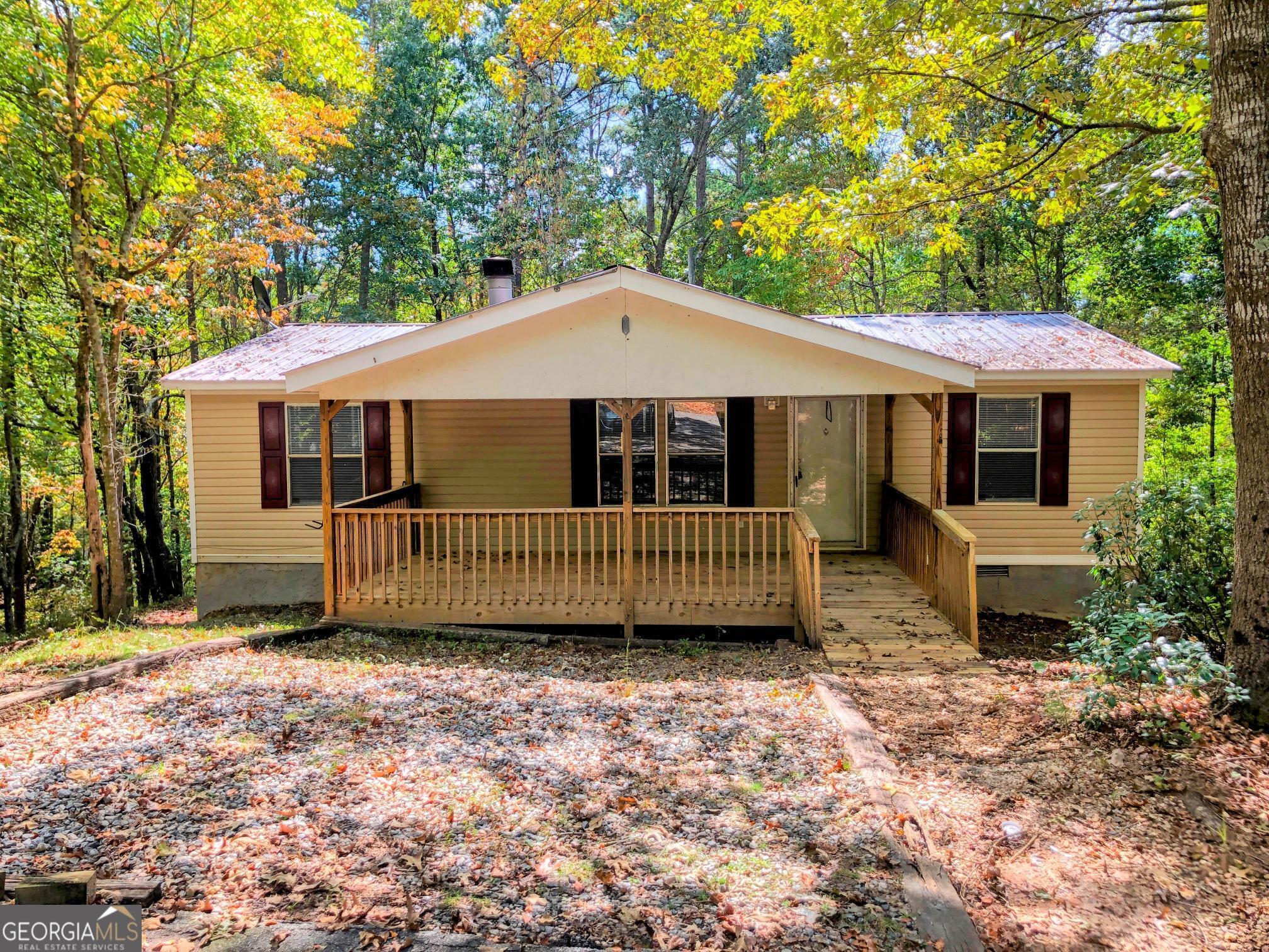 AVAILABLE NOVEMBER 2025 Check out our 3 bedroom 2 bathroom mobile home in Dahlonega, GA! This home is tucked away in a wooded area and features a large covered front porch, living room w/ fireplace, and a large covered rear deck as well. The master has a walk-in closet, garden tub and separate tiled shower! Newer laminate floors throughout for easy cleaning! Large open kitchen and convenient laundry room with dryer included. New paint throughout.
