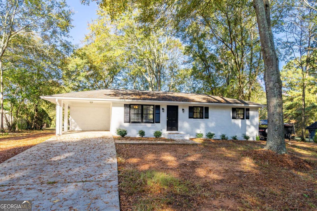 Regions Bank is offering a $10,000 grant to use as your down payment, with no payback! (restrictions apply). Welcome to this 3-bedroom, 1.5-bath home located just minutes from the heart of downtown Social Circle. This classic 4-sided brick ranch offers curb appeal with modern updates. Step into the updated kitchen featuring plenty of cabinet space-perfect for home cooks. The spacious living area offers a cozy, inviting atmosphere. Enjoy outdoor living on the large back deck overlooking a generously sized yard-perfect for barbecues, gardening, or simply unwinding in your private space. The property also includes a one-car carport and driveway parking. Located in an established neighborhood close to shops, dining, schools, and parks, this home offers the charm of small-town living. Don't miss your chance to own this delightful home in Social Circle.