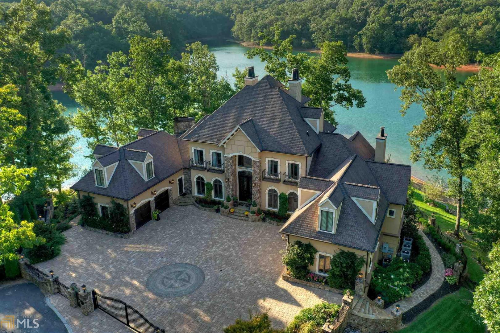 ONE OF THE MOST STUNNING HOMES ON LAKE BLUE RIDGE located within minutes to downtown Blue Ridge! This masterpiece offers elegant, refined & unmatched lake style living with 5BR/4FB/3HB built for entertaining. Main floor features formal living room, formal dining room, office, Gourmet kitchen w/breakfast area & keeping room, master bedroom w/fireplace & spa-like bath, custom tiled flooring & large walk-in closet. 2nd level offers 4 guest bedrooms w/3 private baths & private office/library. 3rd level offers a custom bar, lounge & cozy fireplace. Terrace level offers billiard room, wine cellar, theatre room & exercise room. Outdoor fireplace w/kitchen on main floor, outdoor fireplace on terrace level with pool & hottub. Custom boathouse, 4 car garage w/car lift