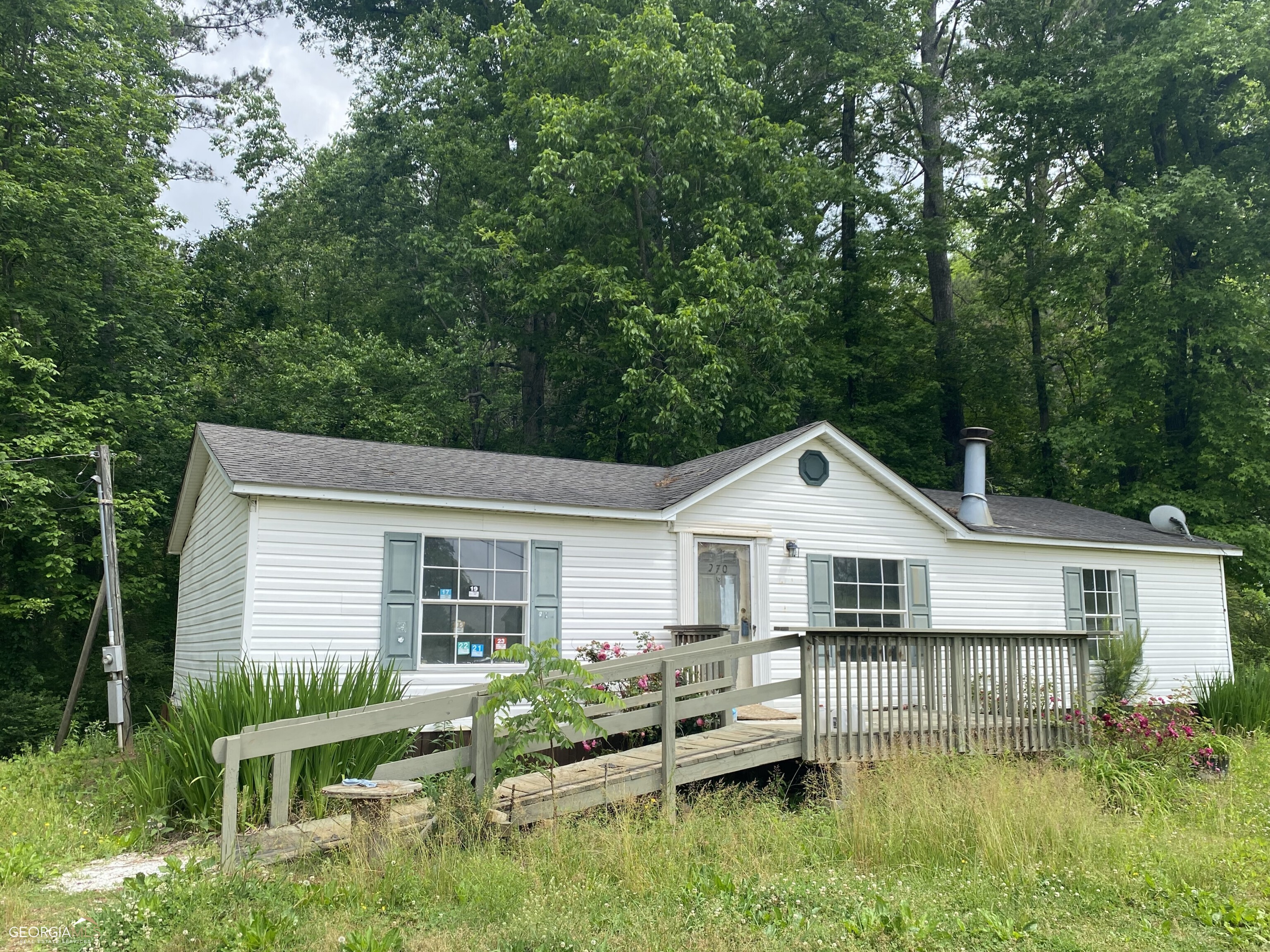 3BR/2BA doublewide mobile home on .94 acres in prime Pickens County location on Hwy 136. Split bedroom floor plan. Galley kitchen with separate eating area. Vaulted Family room w/ fireplace. Ramp to front door. 2 separate storage buildings for tools or equipment. Private back yard. Estate owned. Seller has never lived in home. No disclosures. Sold As-Is.