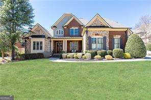Located in the gated community of Winthrop Park, this stunning home offers exceptional craftsmanship and modern elegance. Recently updated with a newer roof and recently refinished hardwood floors throughout, this residence showcases exquisite molding and architectural details. The oversized primary suite is conveniently located on the main level, while the upper floor features three spacious en-suite bedrooms. The gourmet kitchen is a chefCOs dream, boasting sleek stainless-steel appliances, a custom backsplash, and a walk-in pantry, all seamlessly flowing into the family room with soaring ceilings, built in bookshelves and a striking fireplace. Step outside to a covered porch with a cozy fireplace, perfect for year-round entertaining while overlooking the beautifully landscaped backyard. The finished terrace level is bathed in natural light and offers a spacious family room, an exercise room, an in-law suite with an additional bedroom, two full bathrooms, a kitchenette, and ample storage. Situated in a prime Johns Creek/Alpharetta location, this home is just minutes from top-rated schools, fine dining, and premier shopping, offering the perfect blend of luxury and convenience.