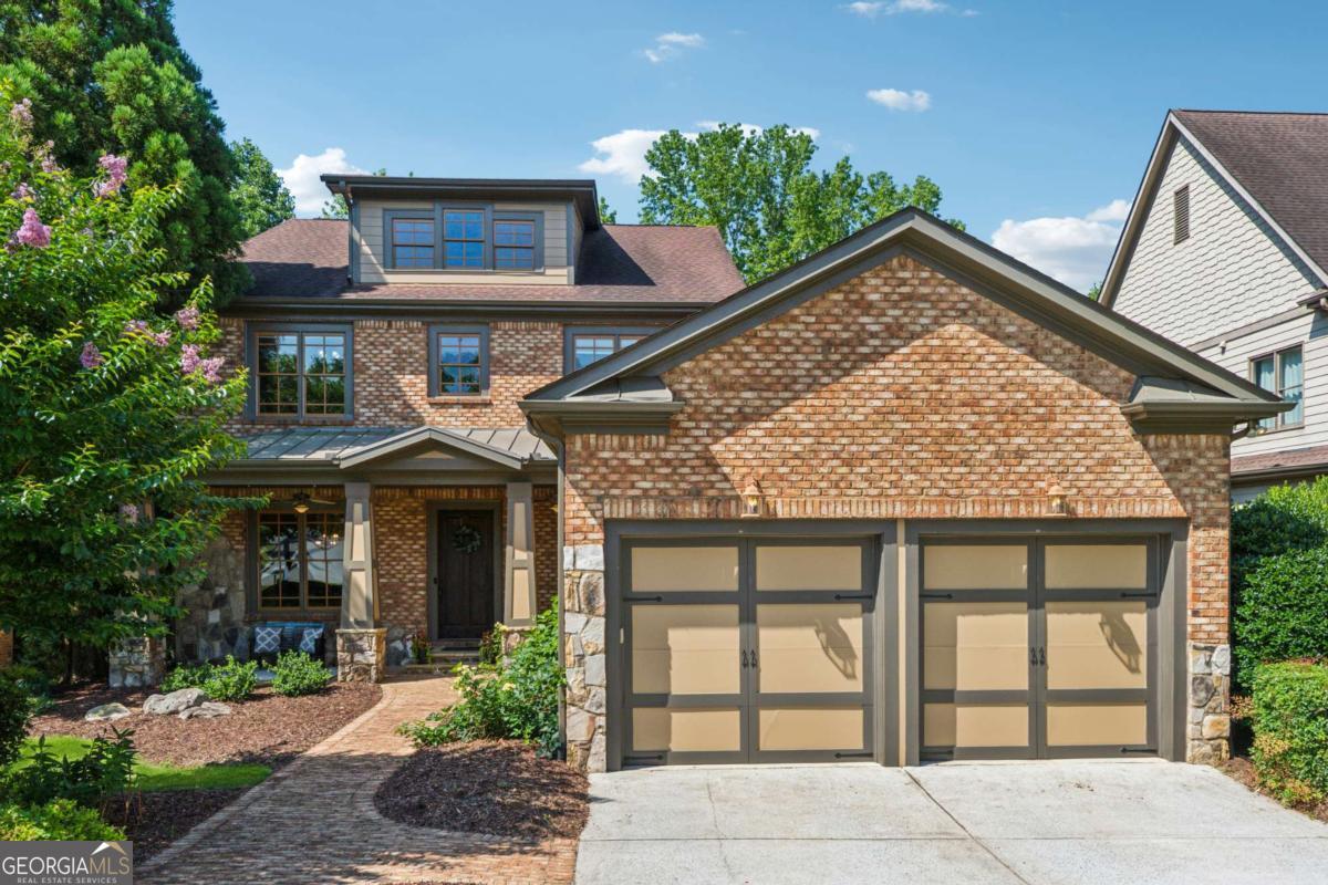 Discover this exceptional, beautifully updated residence nestled within the highly sought-after gated community of Wentworth Manor. Located in South Forsyth County-renowned for top-tier schools and low property taxes-this stunning 5-bedroom, 6-bath home offers spacious, open-concept living spaces designed for both everyday comfort and memorable entertaining. As you approach the covered brick porch, you'll be greeted by freshly refinished hardwood floors that flow seamlessly throughout the main level. To your left, enjoy a generous dining room adorned with elegant wainscoting and crown molding, perfect for hosting family gatherings. To your right, the versatile main-level bedroom, featuring custom molding and glass French doors, provides an ideal space for multigenerational living or a private home office. The expansive, open-concept living area is thoughtfully designed to promote a smooth flow between spaces while maintaining individual character. The family room features a striking floor-to-ceiling stacked stone fireplace and beamed ceiling, creating a warm and inviting atmosphere. The gourmet kitchen is truly the heart of the home, boasting a large eat-in island, custom cabinetry, granite countertops, stainless steel appliances-including a 6-burner gas cooktop with vented hood and double wall ovens-and a spacious walk-in pantry. Adjacent to the kitchen, the charming keeping room with vaulted ceiling and brick fireplace offers a cozy retreat and easy access to the private screened-in deck. The level, fenced, wooded backyard provides a tranquil outdoor setting, ideal for relaxation or entertaining guests. A practical mudroom at the garage entry helps keep your home organized. Upstairs, the luxurious master suite features a sitting area with a brick fireplace, tray ceiling, and a spa-inspired bath with granite countertops, custom cabinetry, a whirlpool tub, and a large walk-in closet with windows. Three additional spacious bedrooms, each with their own bathrooms, along with a well-appointed laundry room with custom cabinetry, complete the upper level. The generous walk-out lower level offers approximately 2,000 square feet of versatile space, perfect for multigenerational living or personalized customization. Featuring large windows that flood the space with natural light, a rough-in for a full bath, and endless potential, this area invites your creative vision. Enjoy the serenity of the private, landscaped backyard-an ideal setting for relaxation or entertaining in a peaceful, wooded environment. This meticulously maintained and updated home showcases fresh paint throughout, extensive molding, 10-foot ceilings, and numerous high-quality upgrades. Conveniently located within walking distance to top-rated Lambert High School, South Forsyth Middle School, Publix, shopping, and a variety of dining options, this home combines convenience with comfort. Welcome to your dream home in a wonderful gated community-your new chapter begins here!