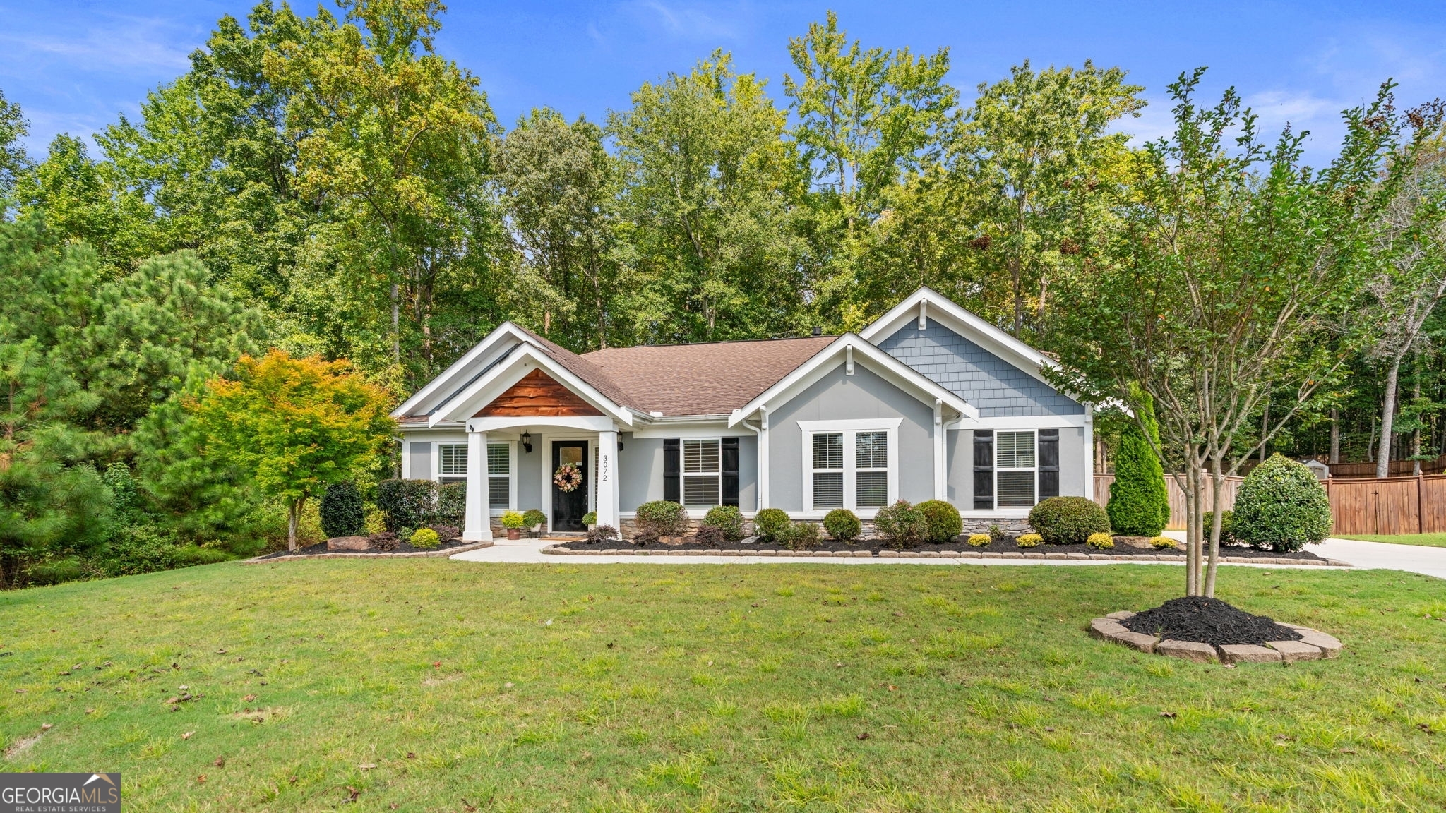 A Move-In Ready Home in a Prime Braselton Location - Discover this welcoming nearly new ranch-style home, built in 2018. The desirable one-level floor plan makes for easy living, while the home's location at the end of a quiet street offers a bit more privacy. Recently refreshed from top to bottom, this home is ready to welcome its new owner. The interior walls have a fresh coat of paint, and the entire home has been professionally deep cleaned. The exterior paint has been freshened, and both the home's exterior and all concrete surfaces have been power washed. New landscaping adds to the home's curb appeal. Step inside to an open-concept living area featuring vaulted ceilings and abundant natural light that fills the space. The low-maintenance flooring provides a seamless flow into the kitchen, which boasts modern appliances, ample cabinetry, and a convenient breakfast bar. The living room is anchored by a stacked stone fireplace, creating a perfect central spot for gathering. The property includes a fenced backyard with a tree buffer, providing a private space for outdoor activities. As part of this gated community, you'll have access to a variety of amenities, including a clubhouse, swimming pool, and lighted tennis courts. The home's location also offers great convenience, with quick access to Highways 211, 53, and I-85 - and is just a short drive from the Chateau Elan Winery, downtown Braselton, the Mulberry RiverWalk, and the Braselton Village, which includes a brand new Publix and Lowe's. Whether you're a first-time buyer, empty-nester, or looking for a peaceful retreat with easy upkeep, offers a move-in ready lifestyle in a welcoming community with top-tier amenities.