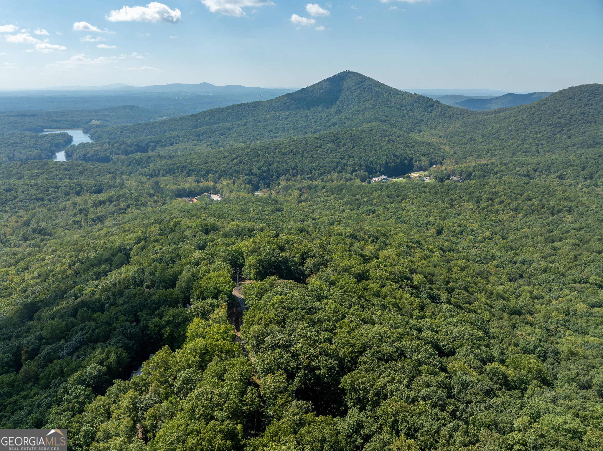 Escape to tranquility with the incredible acre + lot at the top of the mountain in the amenity-rich Bent Tree Community. The homesite is level on the front and slopes to the back, which is perfect for a daylight basement. It is surrounded by gorgeous mountain views, and is located on a highly desirable street with beautiful homes. A favorable level 3 soil test was performed in 2006. This is the best priced lot in Bent Tree! Bent Tree is a gated community located approximately one hour north of Atlanta. Bent Tree amenities are designed to keep you fit featuring a challenging 18 hole Joe Lee designed golf course, indoor/outdoor tennis and pickle ball courts, two pools, pristine Lake Tamarack for kayaking and fishing, many social events and a equestrian center in this beautiful 3500 acre preserve. Abundant wildlife abounds with deer, turkey, bears, raccoons and those unseen call this wonderful place home as well! Now is the perfect time to build your custom home.