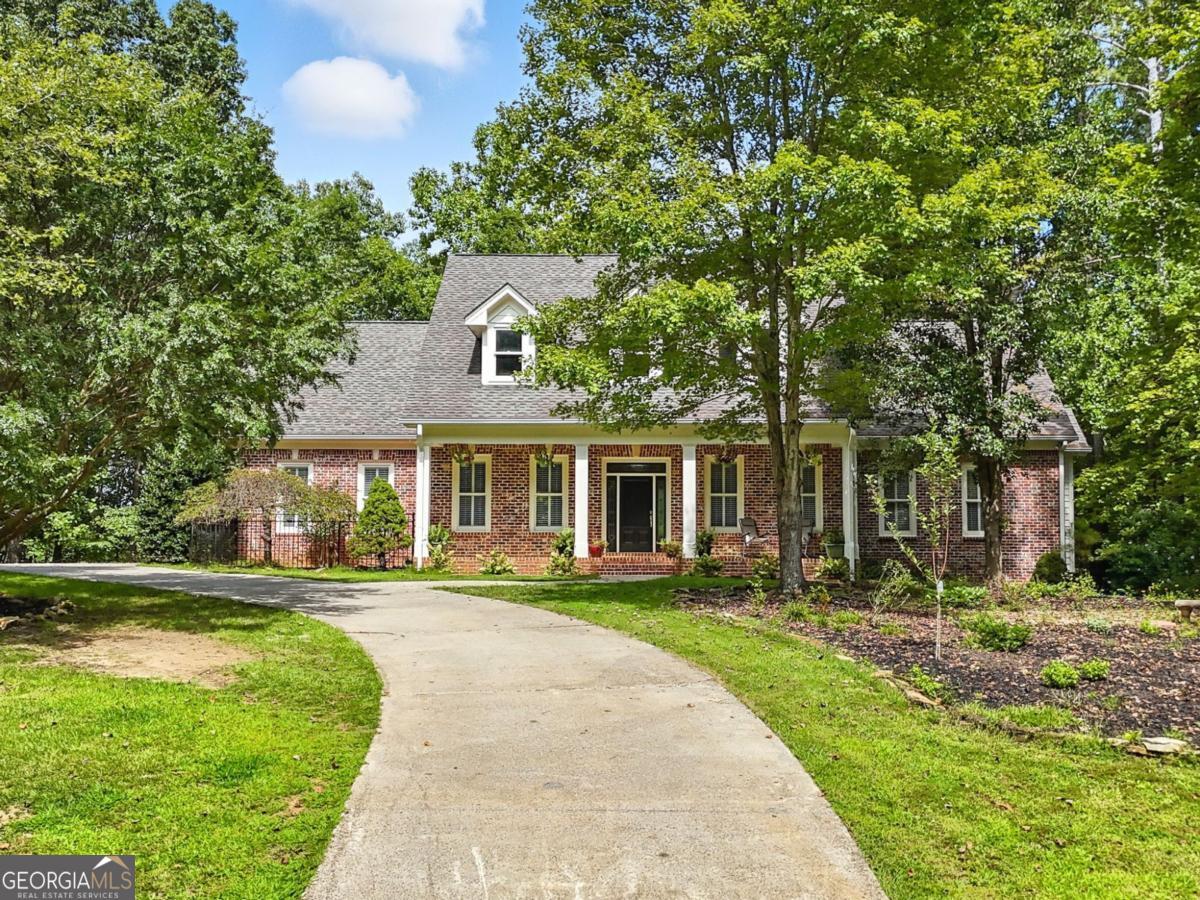 Step through the front door and you'll know-you've found the one. This expansive 6-bedroom, 4.5-bath retreat is tucked inside one of North Georgia's most sought-after gated communities, where mountain views, peaceful vibes, and timeless beauty collide. Built with enduring quality, this four-sided brick estate sits on 1.36 private acres of natural beauty. Inside, the design blends comfort and function effortlessly: Main Level Luxury: A grand primary suite with its own fireplace, a sunlit family room, and a chef's kitchen with stainless appliances, farmhouse sink, endless cabinets, and space made for gatherings. Upstairs Retreat: Two spacious bedrooms, two full baths, and a bonus room perfect for guests, kids, or your dream home office. Terrace Level Potential: Already plumbed and partially finished with a bar and half bath-just waiting to become your in-law suite, entertainment hub, or creative studio. And then there's the outdoors. ?? The current owners have poured heart and soul into lush landscaping, blooming gardens, and fruit trees now entering their second year. From the back deck, you'll hear the tranquil sound of a rushing creek on your own property-an endless soundtrack of nature. The neighborhood? Pure magic. Imagine covered bridges, hidden waterfalls, stocked ponds, and winding trails framed by wild flowers. And just outside the gates-you'll find Canoe Vineyard & Winery, your new weekend hangout spot. ?? This isn't just a house. It's a home filled with life, laughter, and love, waiting for its next chapter. For those who crave luxury, tranquility, and a story worth living-welcome home.