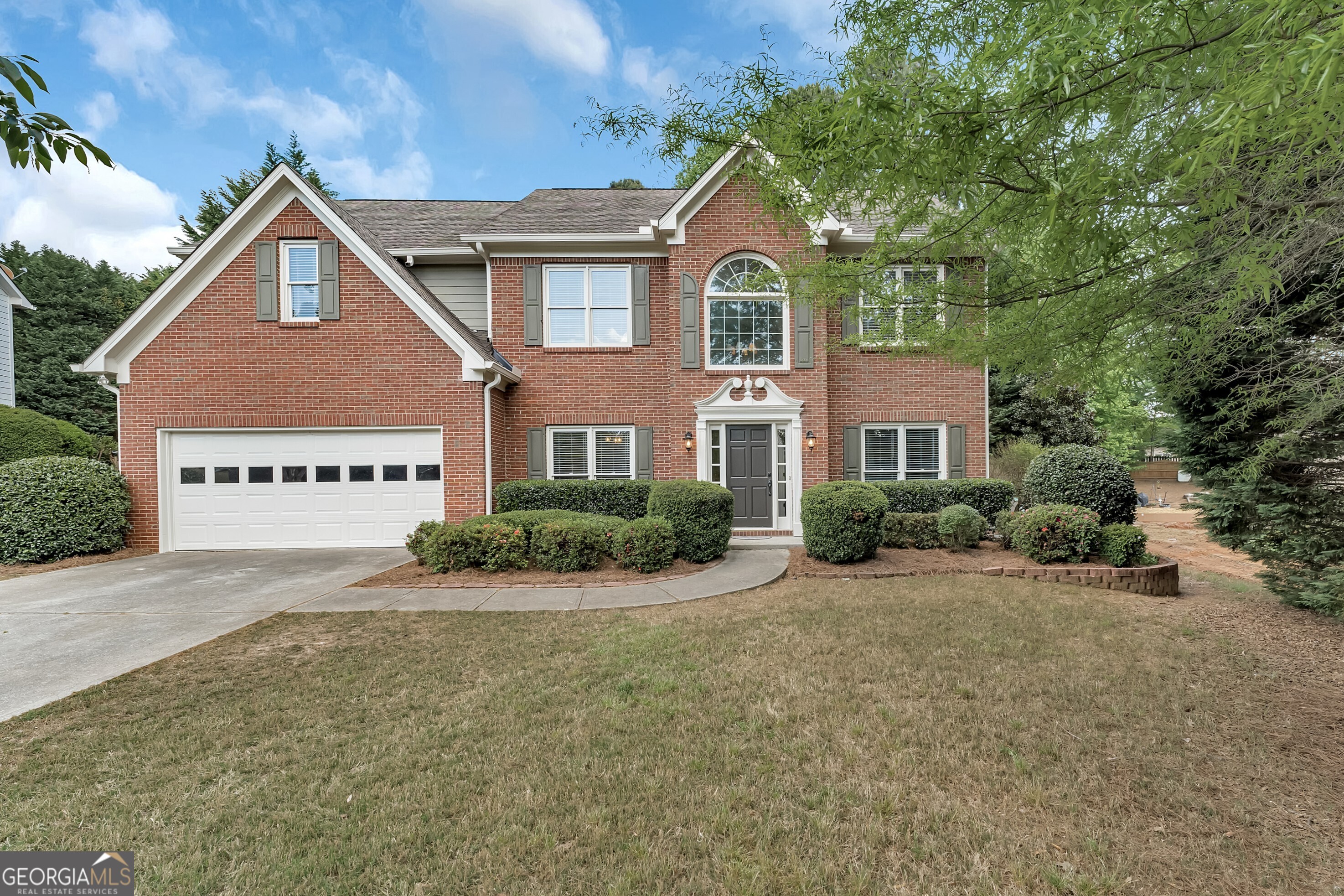 Brick-Front Traditional in Sought-After Windrose! Perfectly positioned just minutes from Halcyon, premier Shopping and Dining, and Top Forsyth Schools, this beautiful home offers the best of both worlds a Coveted Alpharetta Address with Low Forsyth County Taxes. Step inside the Two-Story Foyer Entrance to find a Formal Living Room with French Doors to the right -- ideal for a Home Office, Playroom, or Bedroom -- and a Formal Dining Room with a Tray Ceiling and Wainscoting to the left. The Bright, White Kitchen features Granite Countertops, a Tile Backsplash, and a Sunny Breakfast Room overlooking the backyard. The Fireside Family Room offers the perfect gathering space for relaxing or entertaining. A Powder Room and Laundry Room complete the main level. Upstairs, retreat to the Oversized Owner's Suite with a Tray Ceiling, Walk-In Closet, and a Spacious Ensuite Bathroom boasting Dual Vanities, a Soaking Tub, and a Separate Shower. Three additional Secondary Bedrooms and a Large Bonus Room share a Full Hall Bathroom, providing plenty of room for family or guests. Outside, enjoy an Expansive Patio overlooking a Fully Fenced, Grassy Backyard ideal for outdoor dining, play, or pets. With its prime location and timeless appeal, this Windrose home offers the perfect balance of Comfort, Convenience, and Community Living.
