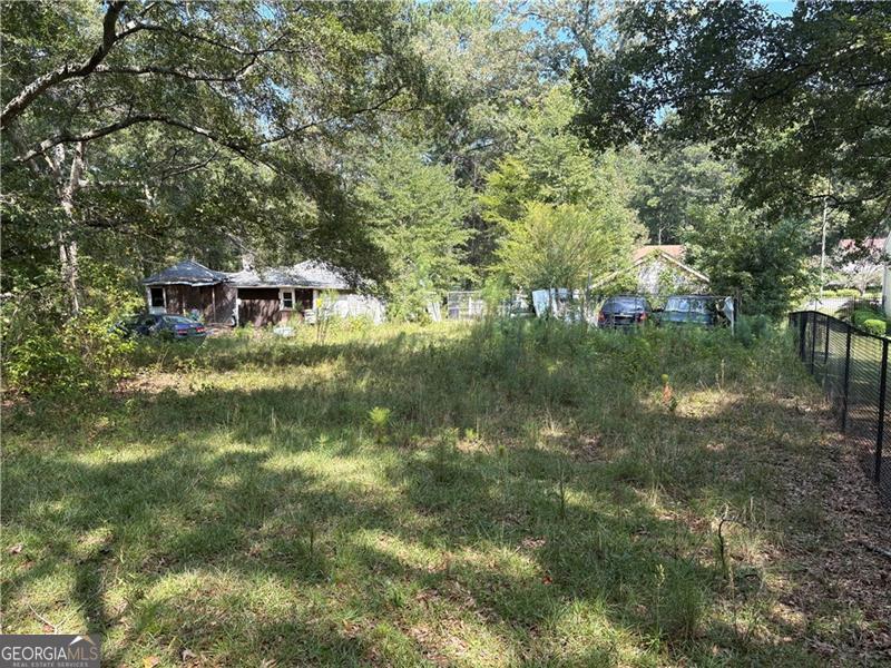 Rare opportunity in the City of South Fulton! This double lot is positioned directly behind the newly built College Heights community and comes with public utilities already in place. A demolition permit has been applied for to remove the existing fire-damaged structure, opening the door for a fresh start. With the potential to subdivide and build two new homes, this property offers excellent upside for builders, investors, or anyone looking to create value in a growing area.