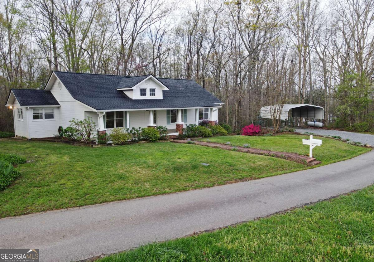 Charming Renovated Farmhouse with Mountain Views in Blue Ridge, - No HOA! Escape to this beautifully renovated 3-bedroom, 2-bathroom farmhouse, ideally located in Blue Ridge, offering the perfect combination of modern comfort and rustic charm. Situated on a quiet, paved street with mountain views, this home is just minutes from all the attractions and amenities Blue Ridge has to offer! The home features an updated kitchen and bathrooms, a brand-new roof, and a newer HVAC system for peace of mind and energy efficiency. The spacious living areas are perfect for entertaining or relaxing, with plenty of natural light, hardwood flooring and cozy details throughout. The unfinished basement offers endless possibilities for additional living space or storage, and the 2-car detached carport provides convenient parking. Best of all, there's no HOA, giving you the freedom to enjoy your property as you see fit. Whether you're looking for a full-time residence or a peaceful retreat, this farmhouse is a must-see! Don't miss your chance to own this beautiful property in one of North Georgia's most desirable areas.