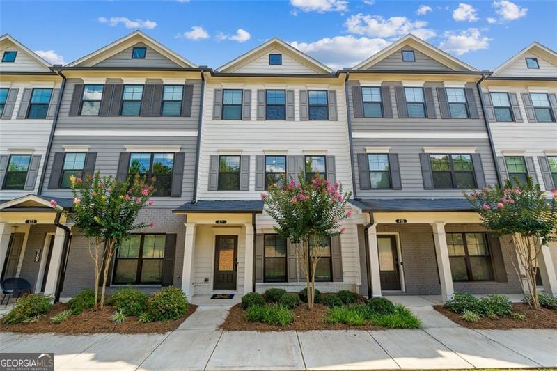 ***Welcome to Modern Elegance in Emerson Heights!!!*** Step inside this beautifully crafted, nearly-new townhome located in the gated and highly desirable Emerson Heights community in Woodstock. Designed for today's modern lifestyle, this spacious three-level home features 3 large bedrooms each with its own private en-suite bathroom and a convenient guest powder room on the main floor. The light-filled, open-concept main level is the heart of the home and an entertainer's dream. The chef's kitchen showcases 42" cabinetry, a massive quartz island that easily accommodates multiple bar stools for casual seating or a quick morning coffee, and a gas range surrounded by designer finishes. The open layout connects the kitchen, dining, and living areas beautifully, while a stylish shiplap fireplace offers a warm, welcoming centerpiece for gathering and making memories. Step out onto the covered deck-perfect for al fresco dining, relaxing with a book, or hosting friends for evening cocktails. Upstairs, retreat to your luxurious primary suite, a true sanctuary featuring a spa-like bathroom with dual vanities, an oversized tile shower, and a generous walk-in closet. Two additional bedrooms with private baths provide space for family, guests, or even a home office. Additional highlights include: Private rear-entry two-car garage Energy-efficient construction for year-round comfort Low-maintenance living with lawn care and exterior maintenance included Location, Location, Location! Ideally situated just off Highway 92, with easy access to I-575, I-75, and GA-400, this home places you minutes from vibrant downtown Woodstock, eclectic shopping and dining in Roswell. Families will also appreciate being near top-rated schools such as Arnold Mill Elementary, Mill Creek Middle, and River Ridge High. This isn't just a home-it's a lifestyle of comfort, convenience, and community. Don't miss your chance to make it yours! Schedule your private showing today.