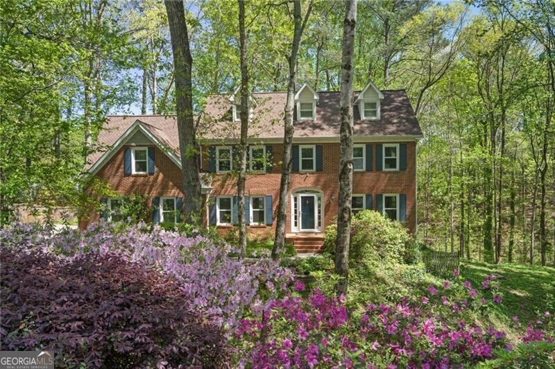 If you're searching for a spacious, beautifully updated home in Roswell or East Cobb-with top-rated schools, neighborhood amenities, and room to grow-this is the one you've been waiting for. Located in the well-loved Hedgerow community, this home offers the largest floor plan available and blends timeless charm with modern updates. A traditional two-story beauty with a Roswell address and Cobb County taxes, this home is nestled on a double, park-like lot surrounded by mature trees and azaleas. Inside, you'll find generously sized rooms, hardwood floors throughout the main and second levels, and durable luxury vinyl plank in the basement. The updated kitchen features quartz countertops, white cabinets, and opens to an expansive sunroom with skylights-perfect for your morning coffee or afternoon reading. The renovated primary bath feels like a retreat, complete with a marble double vanity, soaking tub, and custom closet. Four additional bedrooms offer plenty of space and storage, along with a secondary bathroom featuring a dual vanity. Step outside to enjoy a private stone patio, cozy fire pit, and a landscaped backyard with stone steps leading to a peaceful sitting area. The finished daylight basement with a private entrance is ideal for recreation, home office, or media room. A large workshop with built-in cabinets and separate entrance is perfect for any hobbyist or DIY enthusiast. There's also ample storage off the garage to keep you organized. The Hedgerow community offers two swimming pools, tennis and pickleball courts, playgrounds, and neighborhood events. Close to top-rated schools, parks, shopping, and dining in East Cobb and Downtown Roswell, this home checks every box for suburban living in one of North Atlanta's most desirable locations.