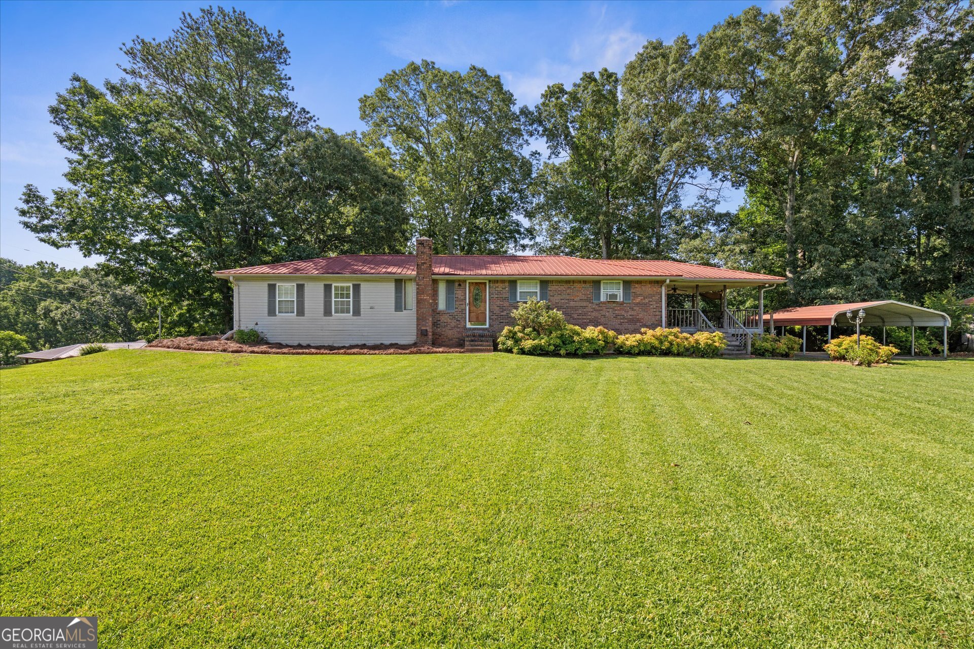 SOLID 4 SIDED BRICK RANCH WITH BASEMENT, SPACIOUS PRETTY YARD, CARPORT, DETACHED 2 CAR GARAGE AND BARN STYLE STORAGE BUILDING ON A CORNER LOT. Summertime is just perfect at this great home. There is a large covered porch perfect to grab and cold drink and catch the cool summer breezes while the kids play and Fido romps in this huge front yard. Inside, you will find a home with solid bones and plenty of character. The front door leads into a formal dining room with a hardwood floor that is spacious to host all the family get togethers. Kitchen has ample cabinet and counter space and has a breakfast area. Check out the size of this family room! Everyone can come over and watch sports here! There are 2 bedrooms each with hardwood floors on the main floor as well as a bonus room which could serve as a 3rd bedroom. Bath features retro tile, walk in shower and wood cabinetry. Large laundry room is just off the kitchen. In the basement, you will find what has previously been used as an apartment with kitchen, family room area, bedroom area and full bath. There is also additional unfinished space in the basement for storage. Detached 2 car garage can be a workshop, garage or maybe even a studio. Gas wall heaters and room air conditioners are present in home along with ceiling fans. Unknown as to whether central heat system works. Does not have central air. Do not walk on the deck, there is a potential safety issue and has been roped off. FHA financing cannot be used due to deck. This home has so much potential, hurry to make it yours today!