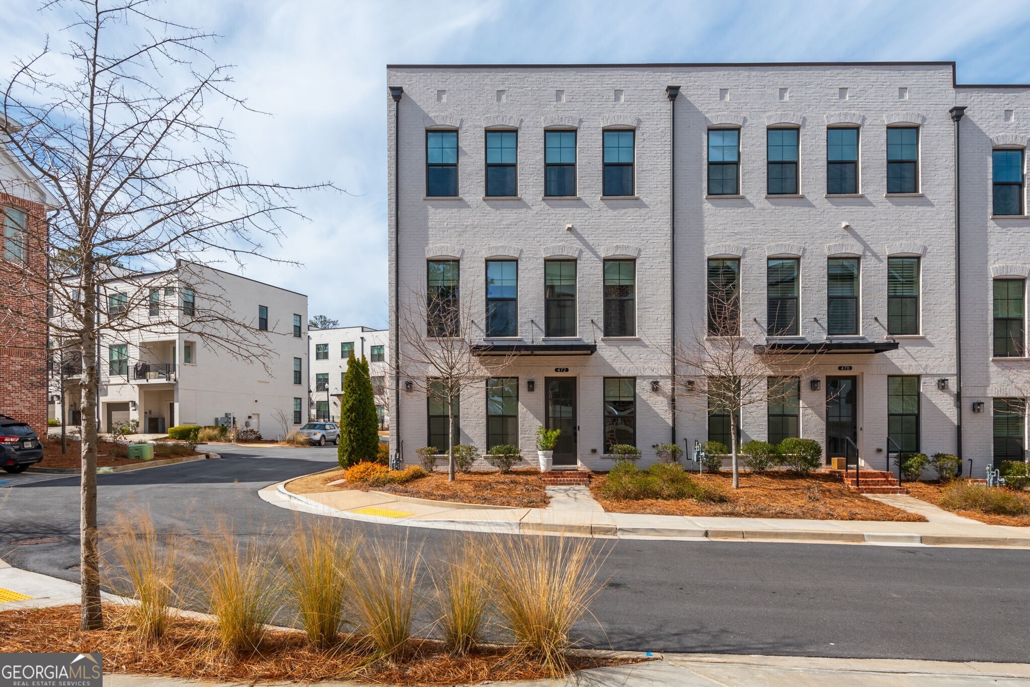 Welcome to The Maxwell, a sought-after Live-Work-Play community in Downtown Alpharetta! This stunning end-unit Brownstone Collection townhome by The Providence Group offers 4 bedrooms, 3.5 bathrooms, and a two-car garage. Inside, enjoy elegant hardwood flooring throughout and an abundance of natural light from extra windows. The designer kitchen boasts a large island, Carrara Moro Quartz countertops, stylish cabinetry, and a beverage nook with floating shelves. The open-concept family room features an acoustic wall and a surround sound system. The dining area shines with elegant picture frame molding, adding a sophisticated touch. Every bedroom features a walk-in California closet system for optimal storage. Residents appreciate the walkability to Downtown Alpharetta and the Alpha Loop, a short bicycle ride or drive to Avalon, seamless access to shopping, dining, and entertainment, including Starbucks, Lily Sushi, Rena's Italian Fishery & Grill, and much more. Enjoy community amenities such as a pool, firepit, and clubhouse. Zoned for Milton High School, this home provides luxury, convenience, and an unbeatable location!