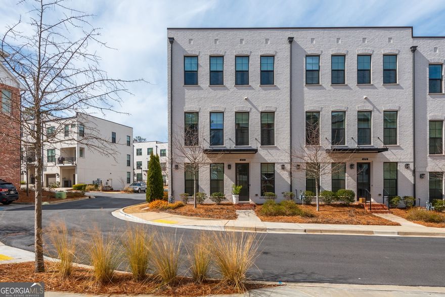 Welcome to The Maxwell, a sought-after Live-Work-Play community in Downtown Alpharetta! This stunning end-unit Brownstone Collection townhome by The Providence Group offers 4 bedrooms, 3.5 bathrooms, and a two-car garage. Inside, enjoy elegant hardwood flooring throughout and an abundance of natural light from extra windows. The designer kitchen boasts a large island, Carrara Moro Quartz countertops, stylish cabinetry, and a beverage nook with floating shelves. The open-concept family room features an acoustic wall and a surround sound system. The dining area shines with elegant picture frame molding, adding a sophisticated touch. Every bedroom features a walk-in California closet system for optimal storage. Residents appreciate the walkability to Downtown Alpharetta and the Alpha Loop, a short bicycle ride or drive to Avalon, seamless access to shopping, dining, and entertainment, including Starbucks, Lily Sushi, Rena's Italian Fishery & Grill, and much more. Enjoy community amenities such as a pool, firepit, and clubhouse. Zoned for Milton High School, this home provides luxury, convenience, and an unbeatable location!