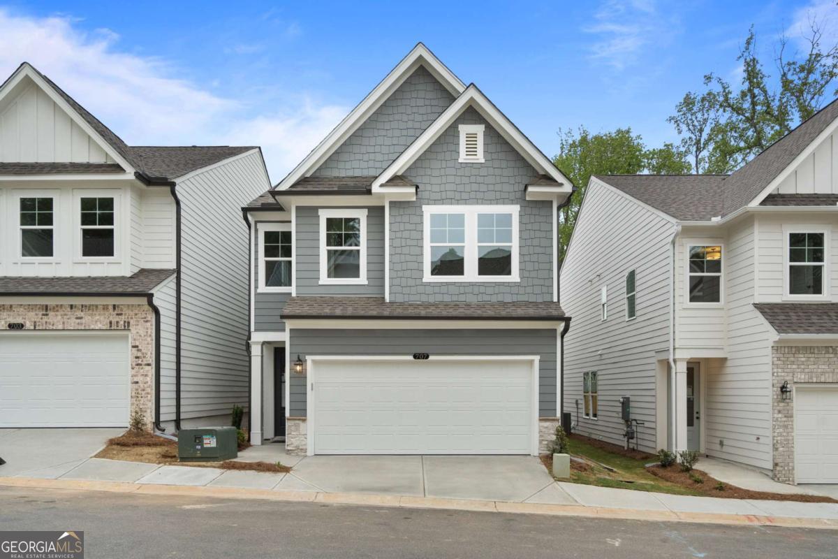 HURRY, FEW HOMES LEFT! Welcome to The Cary A lot 41, a stunning 3-bedroom, 2.5-bath residence in the sought-after GATED Village at Shallowford just steps from pool and clubhouse. This move-in-ready home spans 2,008 sq ft, combining elegance with practicality. The open layout invites you into a bright foyer leading to a gourmet kitchen with 10 FT island, 42" cabinets, gleaming granite countertops, and top-of-the-line stainless-steel appliances. Relax in the cozy living room, complete with a charming shiplap fireplace and 9 FT ceilings throughout the main level, or entertain guests in the adjoining dining room with easy access to the private patio. Retreat to the oversized primary suite, offering a luxurious extended tile shower and a walk-in closet, providing a peaceful escape from the secondary bedrooms. Enjoy the open railing staircase that adds a feeling of light and spaciousness and oak treads on the stairs enhance the sophisticated ambiance. Set within the ONLY gated community with a pool and clubhouse in Kennesaw, enjoy quality amenities and proximity to excellent schools. With its charming exteriors and open floor plans, this home is a true gem. Self guided tours available!