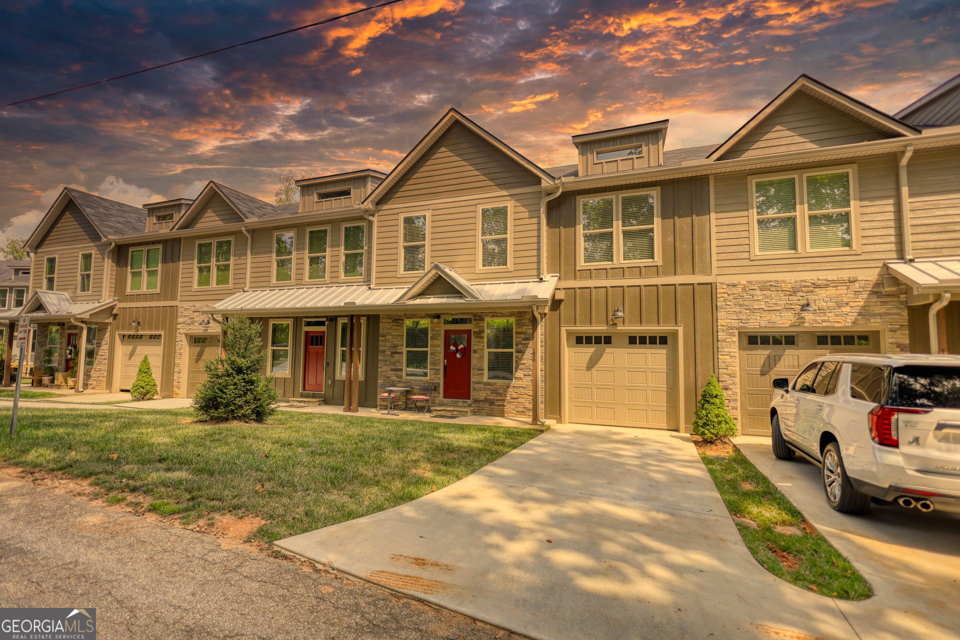 This beautifully maintained 4-bedroom, 3.5-bath townhouse offers a modern and comfortable mountain retreat just half a mile from downtown Clayton. Enjoy the convenience of paved sidewalks that lead straight into town, where shops, restaurants, and local charm await. Built in 2021 and barely lived in, the home features stylish finishes throughout, including a stainless steel dishwasher and range/oven. With three spacious living areas, there's plenty of room to relax, entertain, or unwind after a day outdoors. The recently renovated basement adds even more versatility, while dual one-car garages-one on the main level and another off the basement-offer generous parking for up to four vehicles. Whether you're looking for a full-time residence, a weekend getaway, or a rental investment, this property is a standout option. Located in the heart of a sought-after tourist destination, you're just minutes from scenic trails, waterfalls, and three nearby state parks. Come experience mountain living at its finest in this inviting and picture-perfect home.