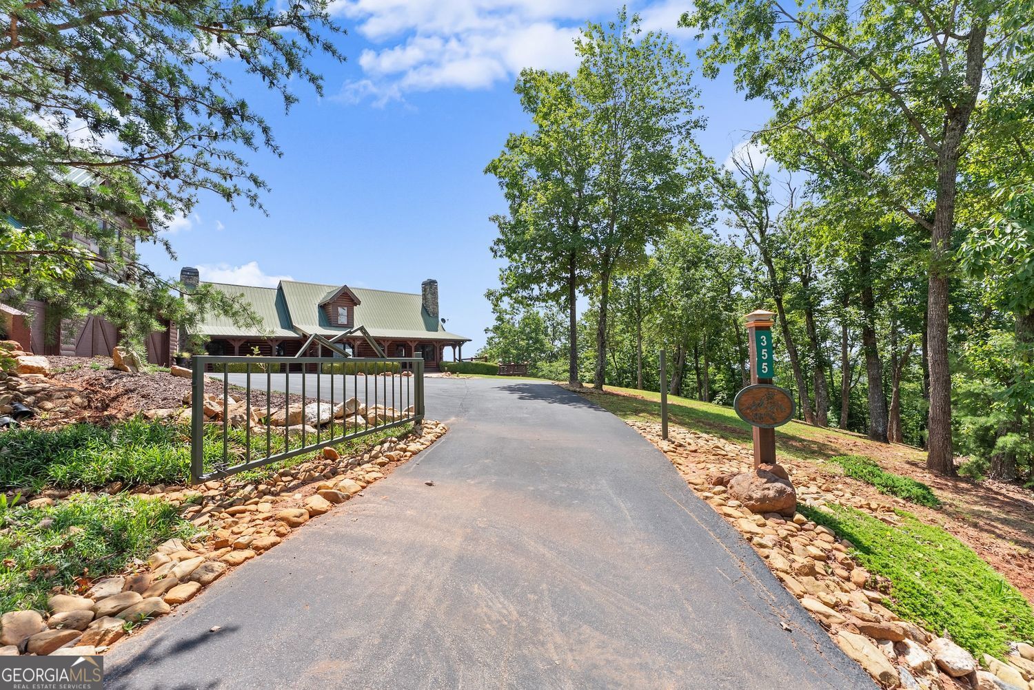 Discover elevated mountain living in this stunning 6-bedroom, 6-bath luxury log home located in the prestigious gated community of Trahlyta Estates, just 8 miles from Downtown Dahlonega. Set on a beautifully landscaped 1.54-acre lot, this 3,762 sq ft custom log home was originally built in 2002 and underwent an extensive high-end renovation in 2020-transforming it into a true mountain showpiece. Enjoy breathtaking panoramic mountain views from the expansive new wraparound covered deck, along with additional layered open-air side decks-perfect for outdoor entertaining and peaceful relaxation. Inside, oversized picture windows frame the natural beauty beyond, flooding the home with light and showcasing the surrounding landscape. The chef's kitchen was fully remodeled in 2020 and features granite countertops, custom cabinetry, high-end appliances, and a massive 7' x 3' island. Renovations also included a complete lower-level remodel, updated bedrooms and bathrooms, and luxury finishes throughout. Also added in 2020: a 28' x 40' oversized three-plus-car garage with a 1,000 sq ft loft apartment above, complete with its own covered deck-ideal for guests, a private office, or potential rental income. Additional features include: 3 fireplaces, In-home fitness room, outdoor firepit, tool shed, freshly stained exterior and new asphalt driveway with front and rear parking. Trahlyta Estates is an intimate 29-home community of luxury log residences, offering both privacy and prestige. No vacation rental restrictions make this a perfect opportunity for a full-time residence, weekend getaway, or investment property. Being sold fully furnished and move-in ready, this turn-key mountain retreat must be seen in person to fully appreciate its charm, craftsmanship, and captivating views.