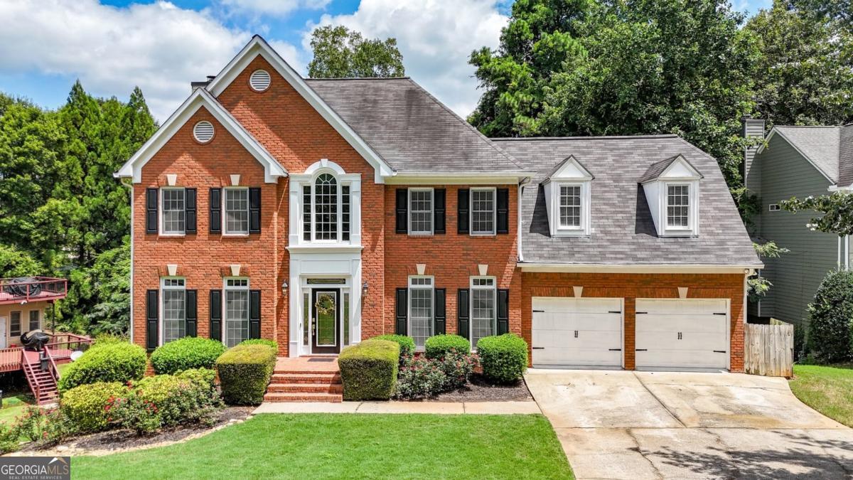 Seller OFFERING ASSUMABLE VA LOAN AT 2.8% (Vet or civilian w/ eligibility requirements and limitations) Welcome home to this stunning 4-bedroom, 2.5-bath traditional brick colonial with 4,000 sq ft of above/below total living space, located in the highly sought-after Stoneybrook Community. The home features a grand foyer with cathedral ceiling, home office, and formal dining room along with an open-concept kitchen with granite counters, modern pendant lights, and a beautiful eat-in breakfast area. Refreshed paint and new carpet recently completed. Upstairs, the luxurious primary suite includes his & hers closets and a marble-finished bathroom with heated floors. Additional highlights include well-sized secondary bedrooms, a large laundry room on the same level as bedrooms, a fully finished basement with a wine bar and extensive possibilities for media, office, game room or home gym, also, there's room for a future bathroom. Enjoy three serene outdoor entertaining areas, Vivint security system with remote monitoring, permanent Christmas lights, an EV-ready garage, and a lush fenced backyard with a peach tree. Stoneybrook amenities include a clubhouse, swimming pool, tennis courts, playground, green gathering space, and community planned events year-round. Truist Park, Smyrna Market, Battery, and the Silver Comet Trail are all within minutes along with a quick commute to downtown Atlanta.