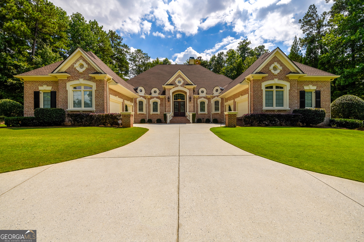Stunning Ranch-Style Abode with distinctive style, lux and craftsmanship.. Prepare to be wowed from the stately circular drive-way and courtyard to the grand barreled ceiling foyer entry. The interior does not disappoint with the homes timeless and tasteful attention to detail. The 12ft ceilings, graceful arch ways, coffered ceilings, ample trim, above door transom windows, lighting, wood plantation shutters and gorgeous hardwood floors HAND scraped by a master craftsman, are just some of the uniquely captivating features of this open, airy, and light filled floorplan! The dream kitchen is highlighted by a massive island and choice granite counters, breakfast bar, custom tile backsplash, top of the line appliances, double ovens, warming drawer, dual dishwashers, bonus double drawer refrigerators and stylish custom cabinetry. The spacious breakfast area and fireside familyroom offer views to the kitchen area. The home features a sophisticated formal dining room which includes a lighted pass-through with stunning granite counter, elegant formal living room showcasing illuminated glass shelved built-ins, a fireplace plus a office/den/music room with french doors. Retreat to the luxurious primary suite with sitting area, access to the covered patio, patio spa/hot tub and private tranquil backyard. Additional highlights include the H//H closets, dual vanities, large frameless shower, and deep jetted soaking tub. Spacious spare bedrooms with ensuite baths and generous sized closets. Delight in hosting or having relaxing moments on the outdoor patio, a true private oasis with stone wood burning fireplace, elaborate cedar veranda, impressive, staked stone columns and beautiful slate tile flooring. For even more relaxation, follow the brick pavers to the covered spa/hot tub. The backyard also provides room for a pool!!!... See attached rendering. Transition to the finished terrace level with like build and quality finishes providing flexible living and entertaining options for access to the home theatre, custom wet bar, kitchenette, lounge, living room and fireside gaming area. Additional features include the recently added 5th bedroom with ensuite, 2nd laundry room, bonus room/fitness center with pocket doors and a huge flex space with 6th full bathroom. New Roof, HVAC System and Hotwater Heater. Home also provides a water filtration system and central vac system. Sugarloaf Country Club provides unparalleled amenities to include optional TPC Sugarloaf membership, featuring a 27-hole PGA golf course, a 60,000 square foot clubhouse, tennis and pickleball courts, a state-of-the-art fitness and swim complex, year-round social events and more. Look no further... Welcome Home!!!