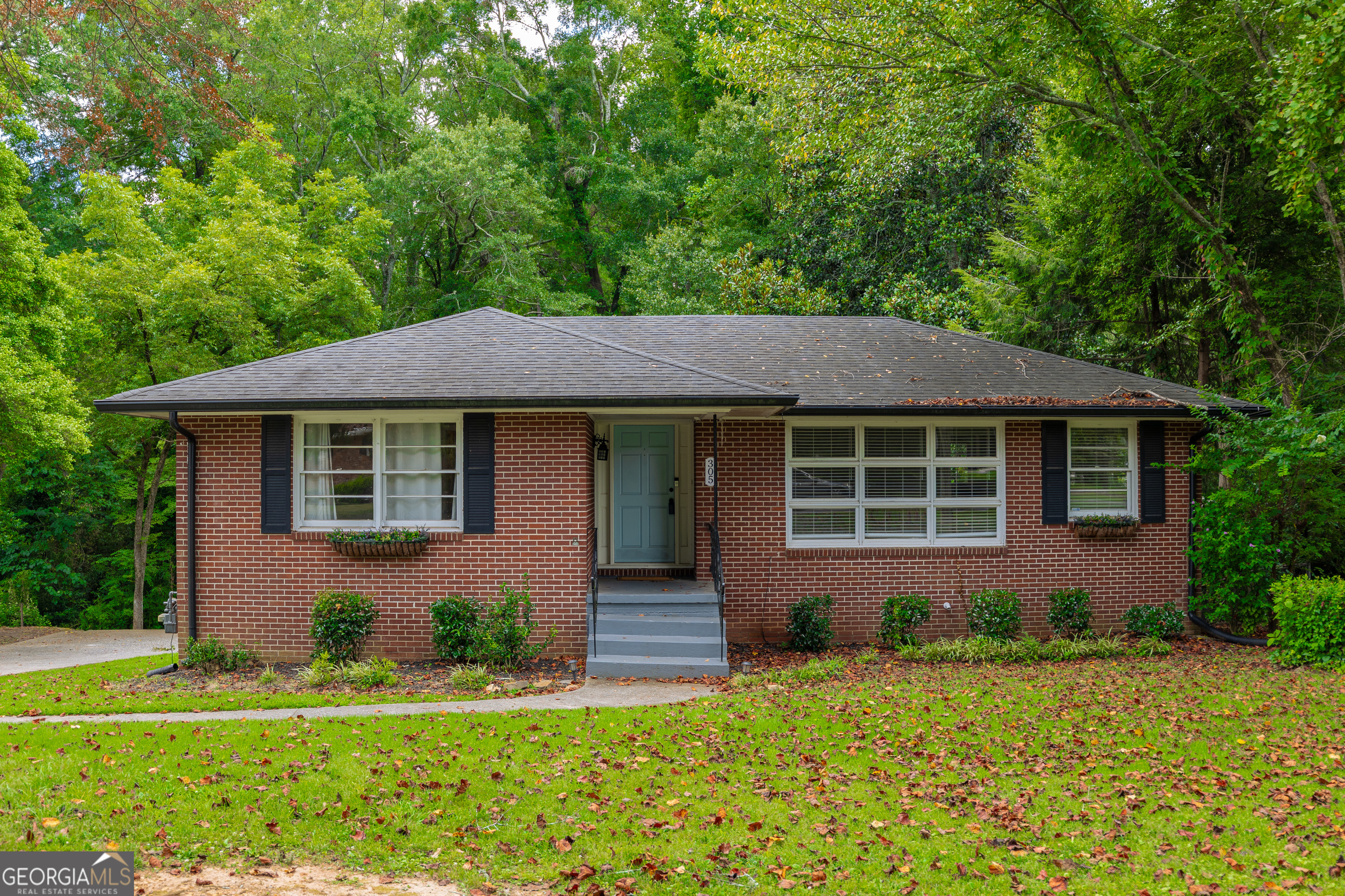 Welcome to 305 Brookwood Dr - an updated mid-century ranch just minutes from the vibrant shops, dining, and events of Marietta Square. This charming home combines classic character with modern updates, offering comfortable living inside and out. The main level features a bright, open layout with stylish finishes and warm hardwoods throughout. Step out back to enjoy a view of your entire back yard from a large deck with stair access to below. Downstairs, you'll find a fully finished basement complete with its own full bathroom-perfect for a roommate, in-law suite, or flexible bonus space. Outside, enjoy the peaceful view of a running creek that borders the property. A portion of the yard is fully fenced, making it ideal for pets to roam safely. Whether you're relaxing on the back patio or exploring the nearby square, this home offers the perfect blend of privacy, convenience, and charm. Don't miss your chance to own this move-in ready gem in one of Marietta's most desirable locations!