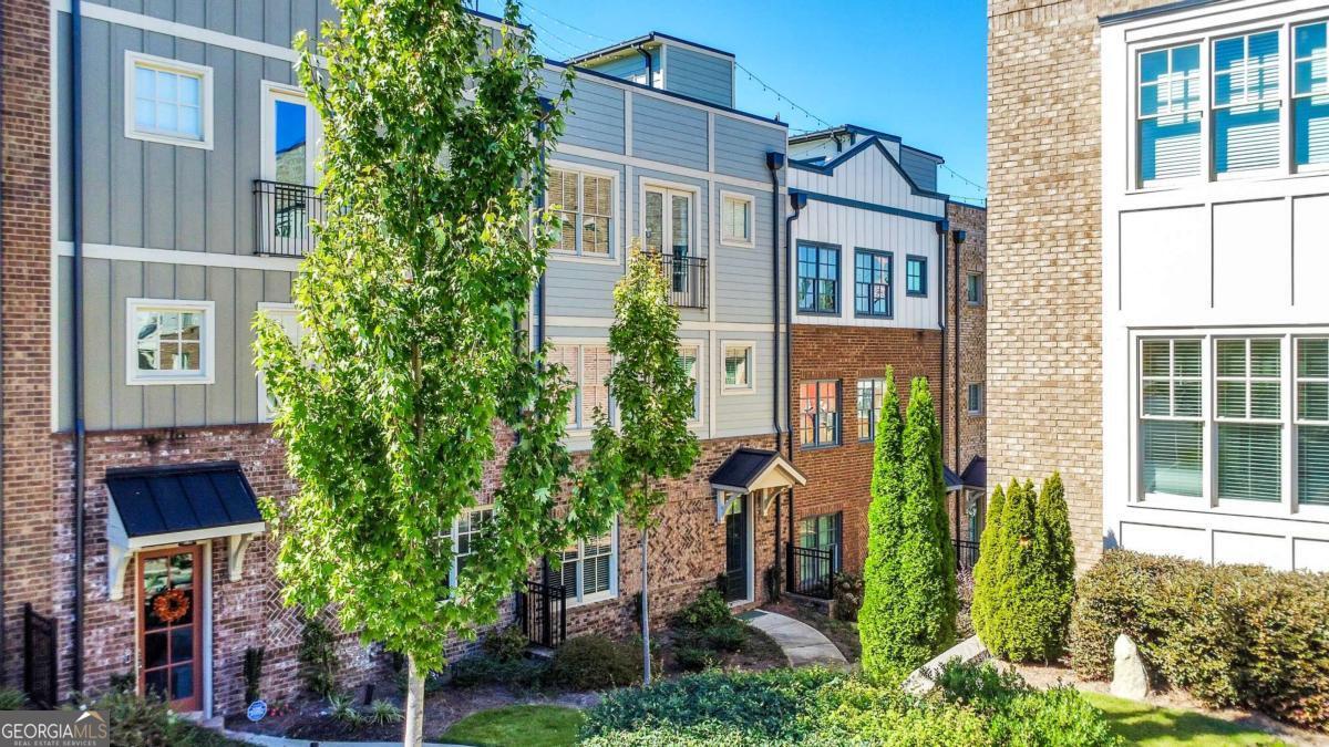 Pack your bags because this is the one! Built in 2020, this stunning 3 bed / 3.5 bath townhome in the highly sought-after Seven Norcross community offers modern design, upscale finishes, and an unbeatable location just minutes from the heart of Historic Norcross. Step inside to an open floor plan designed for both everyday living and entertaining. The gourmet kitchen features a large island, sleek modern lighting, and stainless steel appliances, flowing seamlessly into a fireside family room and spacious dining area. Upstairs, the primary suite is a true retreat with a spa-like ensuite featuring a double vanity, luxurious shower, and soaking tub. A second bedroom on this level also includes its own private bath. The laundry closet is conveniently located on this level making chores a breeze. The terrace level hosts a third bedroom and full bath, perfect for guests or a home office. Enjoy your morning coffee on the covered balcony or take in sunrises and sunsets from the rooftop deck. Living in Seven Norcross means access to a fun and active community with a zero-entry swimming pool, fire pit, green space, and more. Just a short stroll from historic downtown Norcross, you can enjoy shopping, dining, events, and everything this vibrant neighborhood has to offer. Don't miss all this townhome has to offer!