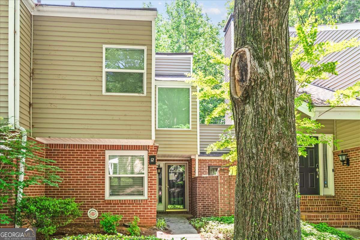 Welcome to 12 Dunwoody Springs Drive, a spacious and stylish residence tucked inside the highly sought-after Dunwoody Springs community. This beautifully maintained home combines modern updates with thoughtful design, offering comfort, convenience, and an unbeatable location. Step inside to an inviting open concept layout filled with natural light. The large living room features a cozy fireplace and flows seamlessly into the dining area-perfect for entertaining guests or enjoying quiet nights at home. The renovated kitchen is a chef's delight, boasting granite countertops, stainless steel appliances, tile backsplash, and generous cabinet space. The oversized primary suite is a true retreat with a walk-in closet and spa-inspired bathroom, complete with a double vanity. A private balcony extends your living space outdoors, offering peaceful wooded views ideal for morning coffee or evening relaxation. The Arbor at Dunwoody Springs offers resort-style amenities including a sparkling swimming pool, tennis courts, a clubhouse, fitness center, and walking trails. With plush landscaping and a serene setting, you'll feel tucked away while still being minutes from Perimeter Mall, Mercedes Benz HQ, GA-400, I-285, and the area's best shopping, dining, and entertainment. Also its one of the communities biggest units considering it possesses 2000 square feet of living space. If you're looking for a move-in ready home that blends style, comfort, and convenience this is the home for you.
