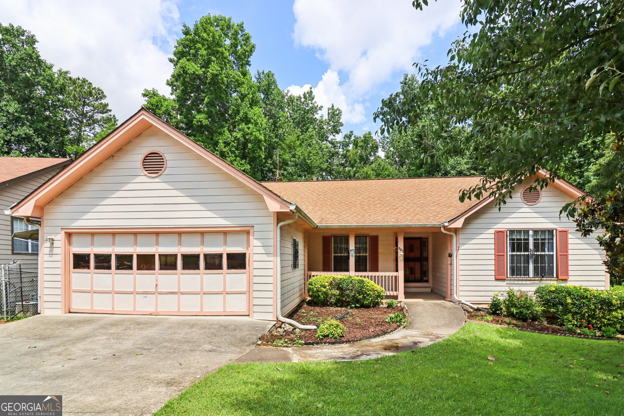 Welcome to 885 Falling Water Ln - a spacious 4-bedroom, 2-bathroom home tucked away in a peaceful Norcross neighborhood. Step inside to a bright and airy living room with soaring vaulted ceilings, creating a warm and inviting atmosphere perfect for both relaxing and entertaining. The open-concept layout seamlessly connects the living area to a generous dining space and a well-appointed kitchen, complete with ample cabinet storage and space for your culinary creativity. The primary suite offers a true retreat, featuring a large ensuite bathroom with a walk-in shower and soaking tub. Three additional bedrooms provide space for everyone. Enjoy your morning coffee or unwind in the evening on the screened porch, overlooking your private, wooded backyard that backs up to serene Freeman Lake-a rare and peaceful view that adds to the home's charm. This home is full of potential and just waiting for your personal touch. Don't miss this opportunity to create your dream home in a beautiful lakeside setting!