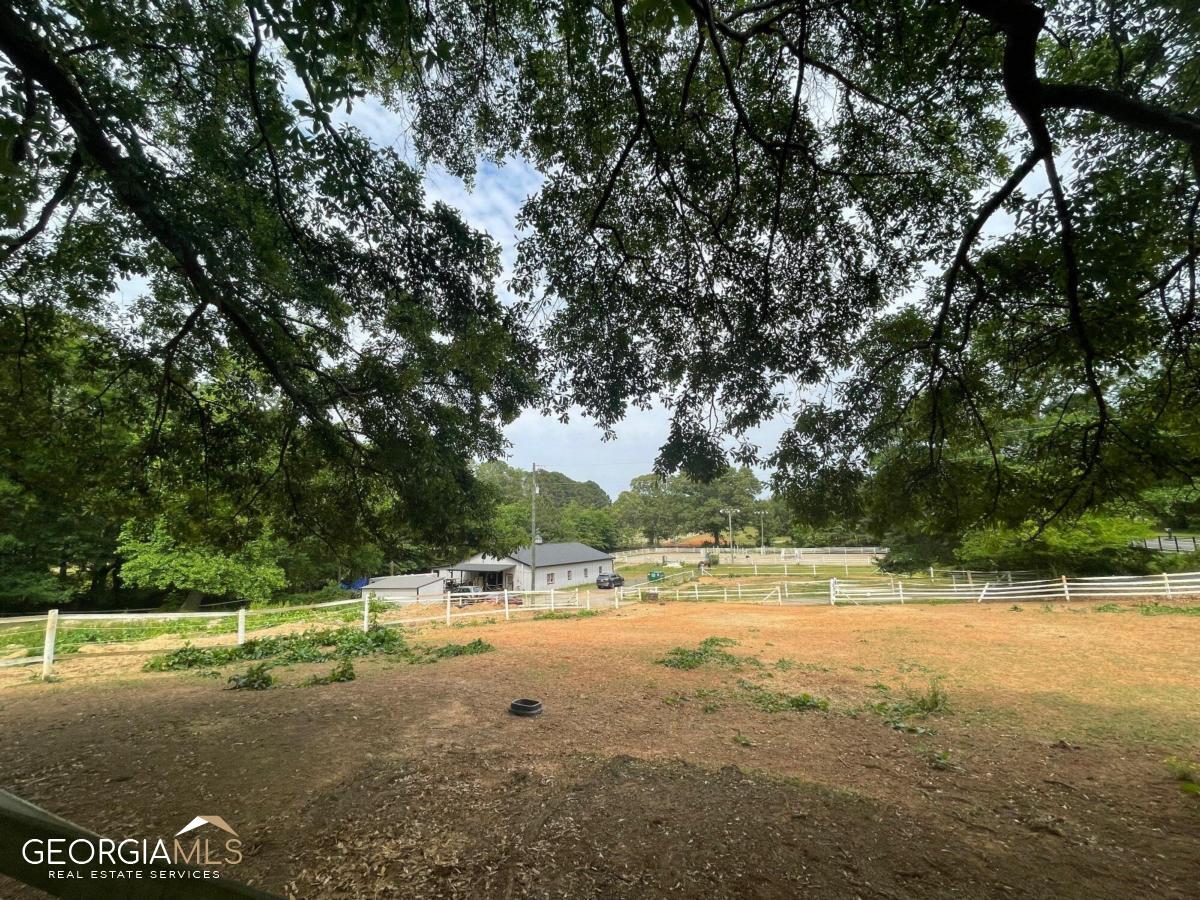 CALLING HORSE ENTHUSIASTS AND LAND DEVELOPERS! This is to be sold with the adjacent lot as we'll for a total of 6.5 acres providing even more potential for expansion or development. PROFESSIONAL PHOTOS COMING! The roof, HVAC system, and water heater have all been recently updated, ensuring a comfortable and worry-free living experience. Perfect for someone to live close to their animals or to act as an office for those working the farm. For HORSE ENTHUSIASTS, this property is a dream come true. With three well-maintained pastures, your equine companions will have ample space to roam and graze. The barn and stables are designed with utmost care and attention to detail, offering a safe and comfortable environment for your horses. Additionally, the arena provides an ideal space for training and equestrian activities. Beyond its equestrian amenities, this property also holds great potential for LAND DEVELOPERS. The generous acreage and prime location make it a valuable investment opportunity for those looking to create a new development or expand an existing one. THE LOCATION of 1323 Blackwell Road is second to none. Nestled in the heart of East Cobb, you'll have convenient access to a wide range of amenities, including shopping centers, dining options, parks, and recreational facilities. Top-rated schools in the area make this property an ideal choice for families as well. DON'T MISS OUT on this incredible opportunity to own a slice of paradise in East Cobb. Whether you're a horse owner seeking a picturesque equestrian property or a savvy land developer looking for an excellent investment, 1323 Blackwell Road is the perfect place to call home.