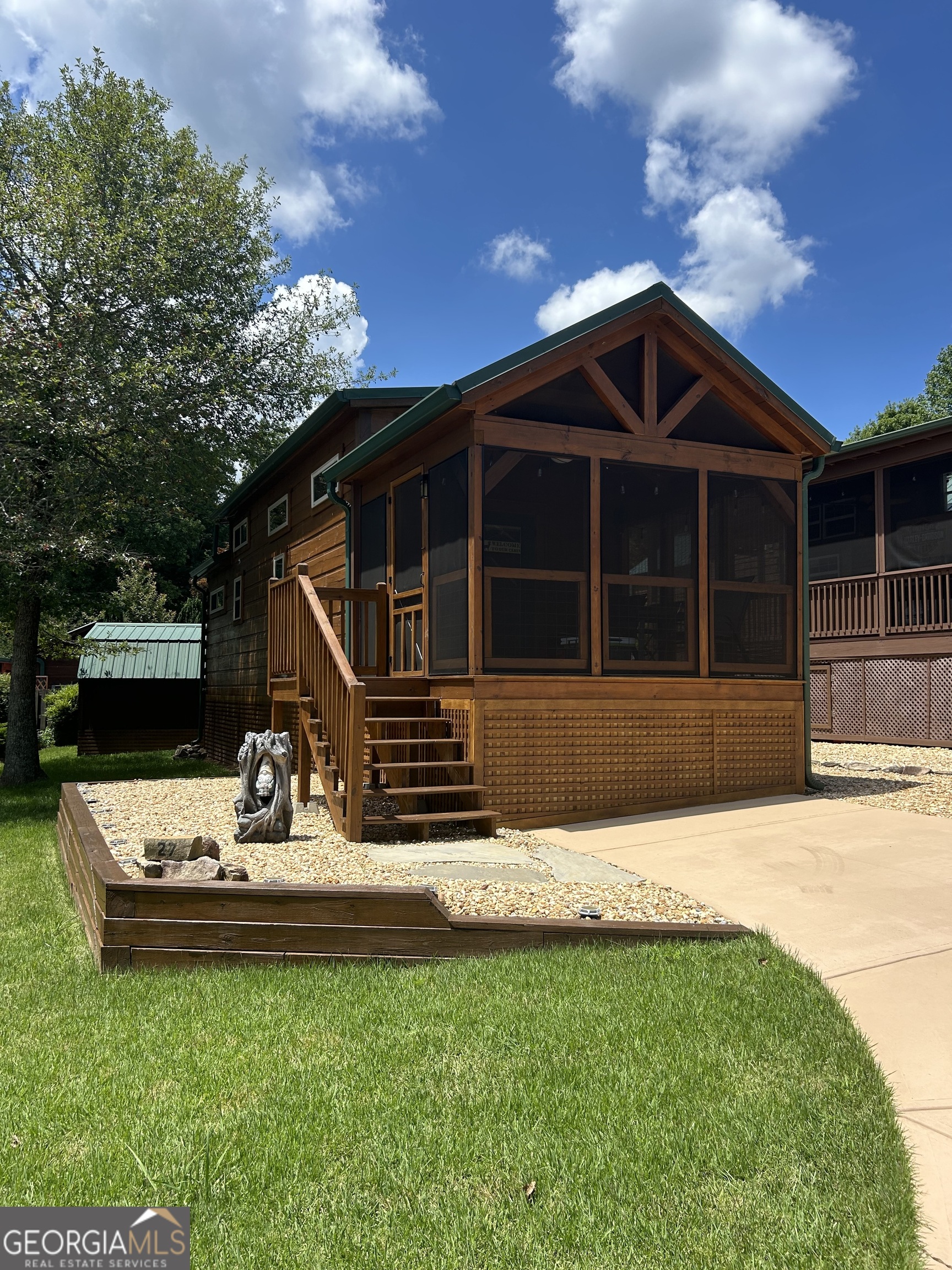 Charming Tiny Home Retreat... 2021 Mountain View Custom Cabin, fully furnished and move-in ready. 1 bedroom, 1 bath with loft and hall bunkbeds. The living room features a cozy fireplace and wood blinds. Kitchen offers stainless steel appliances, quartz countertops, and a washer & dryer. Bathroom includes a walk-in shower with glass doors. Perfect for a weekend escape, seasonal retreat, or year-round living in the gated community of Elkmont Resort.