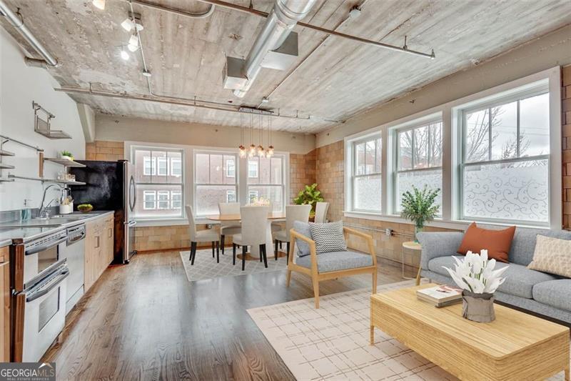 This rare corner unit at the historical Kingan & Co building in the heart of Castleberry Hill is truly one of a kind. The industrial chic style combined with tons of natural light and interesting original features comes together into a stunning city loft. This unit was an office for Kingan & Co, and the bathroom still uses an original bank safe door! Warm honey hardwood floors, open concept kitchen with stainless steel appliances, soaring ceilings, and 2 walls of huge windows. Unit includes 189 sqft of personal storage space in basement. Perks of the building include gated parking lot (1 space plus visitor spaces), fenced dog run, a cozy fitness center, and an incredible rooftop patio! Everything about this condo is an urbanites dream. Conveniently located near public transportation, No Mas! Cantina, Mercedes Benz Stadium, State Farm Arena, Centennial Park, and of course the Castleberry Hill Historic Arts District.