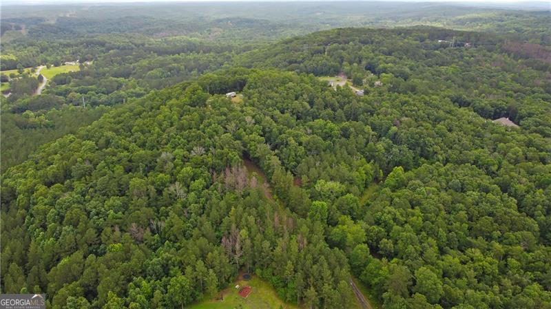 A Rare Mountain-Top Retreat in North Paulding - 10 Private Acres with Panoramic Views - UNDER $200,000!!!! Opportunities like this don't come around often-10 acres in sought-after North Paulding is like finding a unicorn. Nestled at the end of a private drive, this expansive parcel offers the kind of privacy, peace, and natural beauty that's increasingly hard to come by, all while being just minutes from the heart of Downtown Dallas, Cartersville, and everyday conveniences. A couple of gently sloping, cleared acres provide the perfect setting for a custom home, with a soil study supporting septic plans. From there, the land unfolds into a stunning canvas of rolling terrain, hardwood forests, and natural rock formations. Whether you're hiking your own trails or simply enjoying the ever-changing landscape from your porch, this is the kind of property that invites you to slow down and take it all in. 10.01 Acres Perched high above it all, this mountain-top setting delivers jaw-dropping, 360-degree views that feel more like the North Georgia mountains than suburban Dallas. You'll experience the tranquility of being "away from it all," without sacrificing access to modern life. Design your dream home, weekend retreat, or forever sanctuary right here-where nature meets possibility, and the view is yours to own.