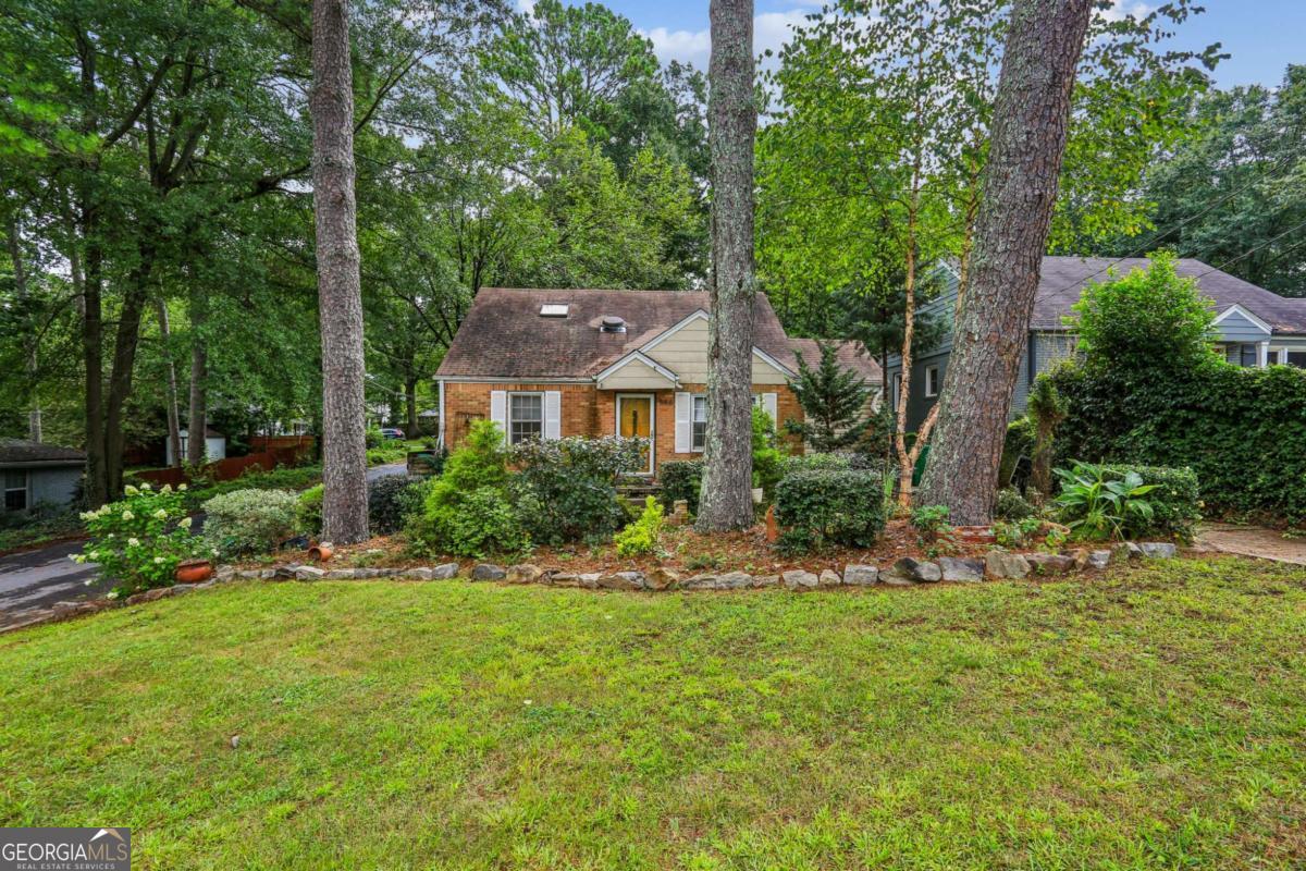 Best value in East Lake Terrace on landscaped corner lot! This 3-bed, 2 full bath cottage has hardwoods and potential throughout. The backyard is an entertainer's dream with established garden beds, miniature greenhouse, and outdoor office steeped in natural light. Enter the living room with full laundry/utility room off it. The open-concept dining/kitchen has white vintage cabinetry and separate pantry space. Down the hall are two bedrooms and shared full bath. The upstairs has private bath, multiple storage options and owner's bedroom. Just blocks to East Lake Golf Course, Buena Vista Lake/park, and dining/shopping! Schedule today to see 586 Daniel!