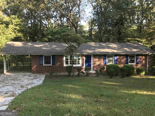 IF YOU LIVED HERE, YOU COULD WALK ONE OF THE ENTRANCE GATES OF STONE MOUNTAIN PARK!!! Do not miss this Amazing 3 bedroom 4-sided brick ranch with attached carport and beautiful Oversized Deck. Enormous Chef's Kitchen with stainless appliances and tons of cabinet space, new granite counters, garbage disposal, dishwasher, new blinds, Hardwood Flooring throughout, Separate Dining area, Island that accommodates bar stools, completely renovated bathrooms and enormous fenced in back yard. Home has a new roof and new windows. DO NOT MISS THIS ONE!!!!