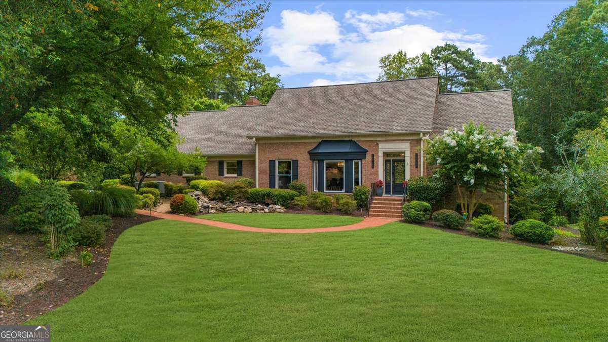 Nestled on a private, one-acre lot just moments from Highway 400 and the serene Chattahoochee River, this fully remodeled luxury estate offers a rare blend of elegance, privacy, and convenience. Located in the exclusive Huntcliff community-home to the Cherokee Golf Course and Cherokee Country Club- Step inside this breathtaking 3-story, 5,000+ sq ft residence and be welcomed by soaring floor-to-ceiling windows, an open-concept design, and flawless attention to detail. The main living and dining areas are flooded with natural light, complemented by a beautifully updated kitchen featuring a granite stone backsplash, and sleek finishes throughout. Every subfloor has been upgraded and topped with new flooring, and the entire interior has been freshly painted. Downstairs, the finished basement offers a full in-law suite or guest bedroom with its own bathroom and a naturally cooled wine storage room-Includes designated entertainment areas and a spacious unfinished section ideal for extra storage. all with views to the lush backyard. Outside, enjoy your own private paradise: a professionally landscaped backyard with mature greenery, a heated saltwater pool, Jacuzzi, and tranquil seating areas in a park-like setting-perfect for entertaining or quiet retreat. Additional upgrades include ,Brand-new upper-level AC unit (installed June 2025, Smart home technology throughout, New electrical panel, Abundant recessed lighting for modern ambiance This one-of-a-kind property combines timeless charm with today's luxury updates-all in one of North Atlanta's most sought-after communities.