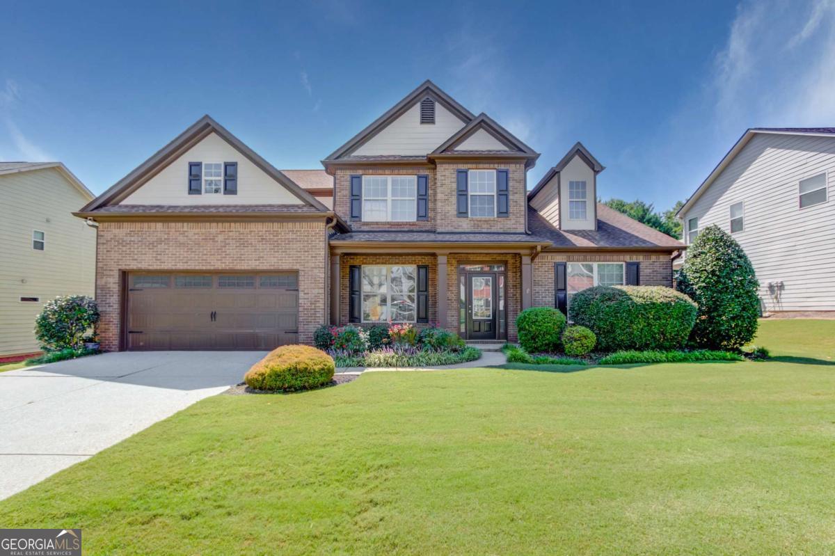 Amazing house in a quiet subdivision near neighborhood shopping, a beautiful county park, and convenient to Interstate 85, Highway 316, and the Mall of Georgia. The main level features a grand 2-story entrance foyer, formal dining room, and massive open kitchen that features ample cabinetry, a gas cooktop, wall oven, built-in microwave, and large island that overlooks a keeping room area with dual sided fireplace. Additional main level features include a two story family room with soaring windows, a primary bedroom with hardwood flooring, spa type bath with soaking tub, separate shower, large walk-in closet. Last, the laundry room is large and has a lot of cabinetry, and there is a powder room guest bathroom. The upper level features a second full suite with walk in closet and full bath, the additional two bedrooms share a bathroom between them. The rear yard is private and has a wooden privacy fence.