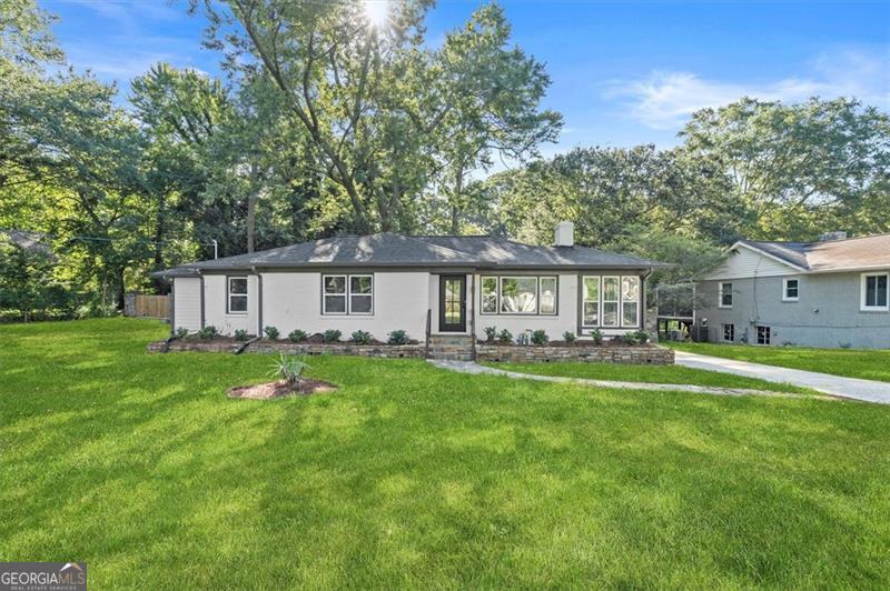 Welcome to 1340 Downs Drive SW Atlanta. Enjoy this gorgeous, fully renovated and updated four sided brick, 3 bedroom 2 full bathroom ranch on a partial basement. Located in the Contra Villa neighborhood adjacent to Venetian Hills, this home is situated just 2 miles from the Beltline and walking distance of the scenic Adams Park and sits on .49 acres. Outstanding new features of this move in ready home include the following: New roof, new windows, new gutters, new AC condenser, new water heater, new rear deck, new primary bedroom add on (fully permitted), new kitchen cabinets, fixtures, quartz countertops, stainless steel appliances and soft close drawers, both bathrooms are outfitted with new tiles, toilets, vanities, shower door, new and refinished hardwoods in the common area, new LVP throughout remainder of the home, new lighting throughout, new interior plumbing, new electric service line including new electrical panel, outlets, switches and wiring, new interior and exterior doors, new paint inside and out and new garage door, with garage updated to accommodate electric vehicle charging capability. The flow of the kitchen, dining and living rooms makes this new open concept highly desirable. The amazing location of this home is just 10 minutes from I-285 and I-20, 15 minutes from downtown Atlanta and Hartsfield Jackson airport and trendy shopping, restaurants and public transportation.