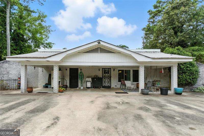 WOW!!! UNDERGROUND HOUSE!!! Come live your childhood dream of how cool it would be to live in an underground house called a BERM HOUSE. Experience the perfect blend of sustainability and comfort in this 2 bedroom 2 bathroom, room mate/ split plan home with separate entrance is sure to peak the interest of those looking for privacy and protection. Built with energy efficiency in mind, this home is partly earth sheltered with soil surrounding 3 sides to provide natural insulation, keeping utility costs low and interior temps stable year round. The front of the home is exposed and features large windows that flood the interior with natural light. The earth covered sides offer exceptional soundproofing and wind protection. Whether you're looking for an eco friendly lifestyle or a uniquely charming home that blends harmoniously with nature, this berm home is a rare find. This home would make a perfect primary residence as well as an investment for long or short term rental. Easy access to Berry and Shorter Colleges as well as the Rome Braves. Close to shopping, dining, medical facilities and activities. Cash or private lender only. Will not qualify for conventional financing due to its uniqueness.