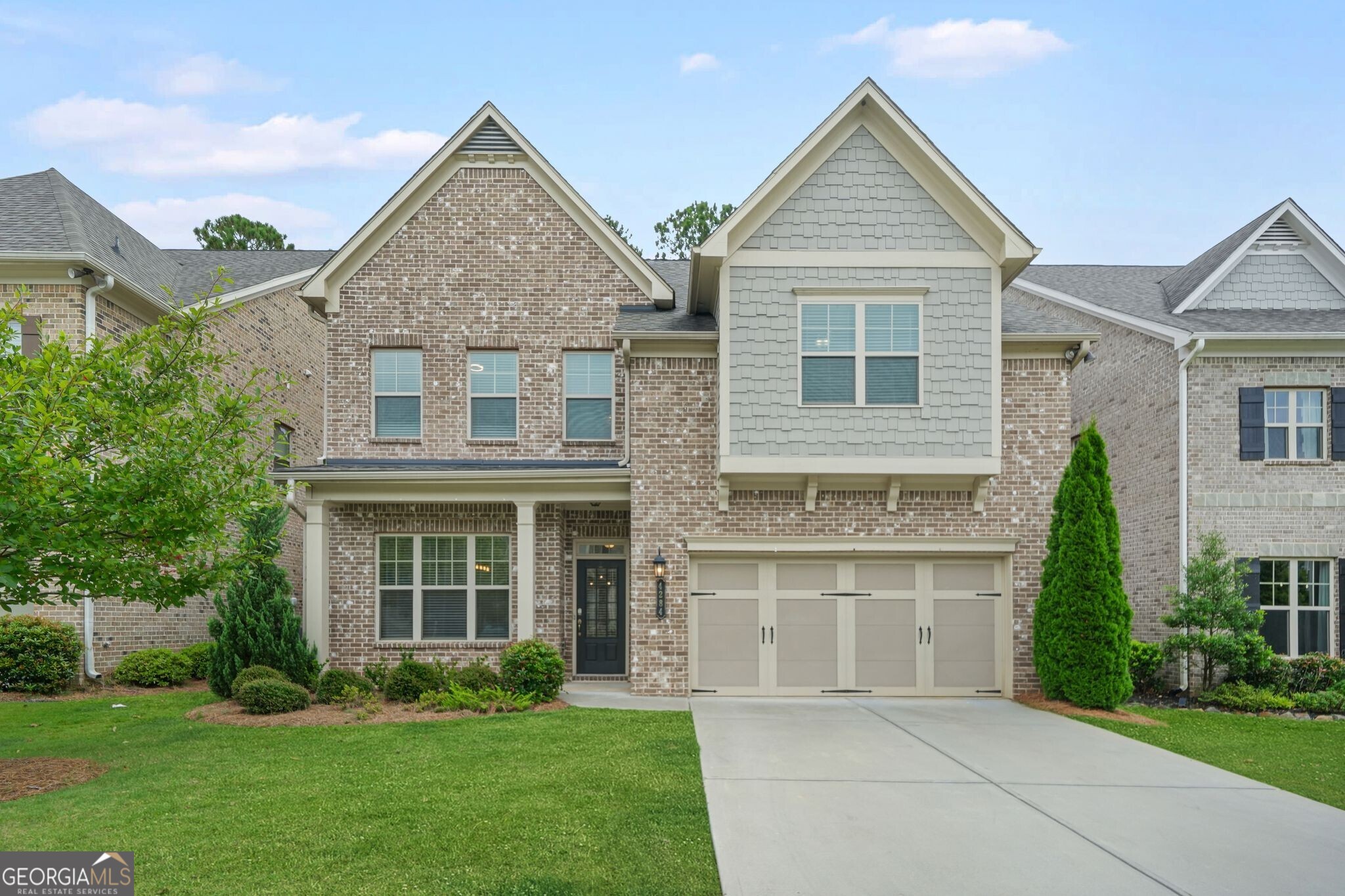 This beautiful 4-bedroom, 3.5-bath home checks all the boxes! The main level boasts soaring 10-foot ceilings, a formal dining room, and an open-concept kitchen and living area, perfect for entertaining or everyday living. The chef's kitchen features quartz countertops, a tile backsplash, stainless steel appliances, double ovens, a prep island, an expansive peninsula, under-cabinet lighting, and abundant storage. The living room centers around a cozy fireplace flanked by custom built-ins and flows seamlessly to a private backyard and patio; plus, the HOA handles all yard maintenance for truly easy living! The main-level primary suite is a retreat with a tray ceiling, two walk-in closets with custom organization systems, and a spa-like bath. Upstairs, 9-foot ceilings enhance the airy feel of a versatile loft space. A large bedroom with an en suite bath is perfect for guests, while two additional bedrooms share a jack-and-jill style bath that also connects to the loft. A massive bonus/flex room offers endless possibilities and could be an office, gym, playroom, or even a fifth bedroom. Collection at Perimeter Park offers fantastic amenities, including a pool, gym, and playground, and is conveniently located near downtown Chamblee, Dunwoody, Brookhaven, and major highways for easy commuting.