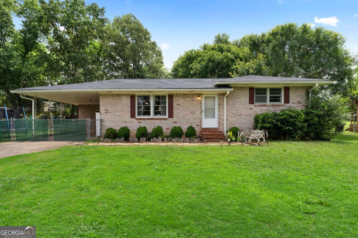 Welcome to this beautiful brick ranch in the HEART of Cartersville, conveniently located just minutes from HWY 41! When you walk in the front door you are greeted with an open layout of the living and dining room. The kitchen features beautiful blue cabinets with a breakfast bar overlooking the living room giving an awesome hangout space. The house features 3 bedrooms, one being the massively spacious primary! You will notice a bathroom with ample size to accommodate your family! This house sits on a spacious flat lot with an amazing backyard to host guests! Don't miss out of this beauty of a house and the potential it exhibits!