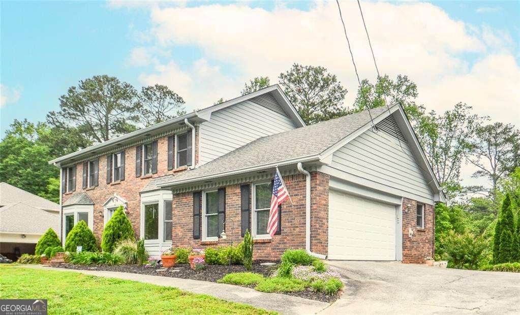 Multi-generational living is easy in this beautifully maintained and well-loved home in Lilburn's esteemed Parkview High School Cluster. This house is gracious and serene. On the main floor you'll find hardwood flooring, a formal and a fireside living room that are open and create a beautiful, large entertaining space filled with natural light, the large eat-in kitchen with granite countertops, a breakfast bar, pantry shelving with pull-out drawers and views to the lush back yard, plus a laundry room, updated half-bath, and a large separate dining room. Upstairs you'll find 4 bedrooms and 2 full bathrooms, including the oversized Primary Suite with walk-in closet. The Primary ensuite bathroom has built-in storage and a double vanity. Downstairs the full, finished, walk-out basement is perfect as an in-law suite, teen suite or flex space - featuring a large full kitchen with ample dining space, a full bathroom, a room that can be used as a living room and a room that can be used as a bedroom. There is brand new carpet in the rec room and potential bedroom, plus a brand new water heater and expansion tank! Outside you'll enjoy the large, multi-level deck and lush back yard. Colorful flowers and plants surround the property. The neighborhood has NO mandatory HOA, and offers Optional Swim and Tennis membership. The location is incredibly convenient, too - one mile to groceries and gas, convenient to highway 78, Ronald Reagan Parkway, restaurants, entertainment, schools, Gwinnett County Public Parks, Trails and Athletic fields, as well as Lilburn City Park, which regularly hosts free community events like Concerts and Food Trucks, plus the wonderful shops, restaurants and music venue on Main Street. This location is also convenient for those commuting to Decatur, Emory and the CDC.