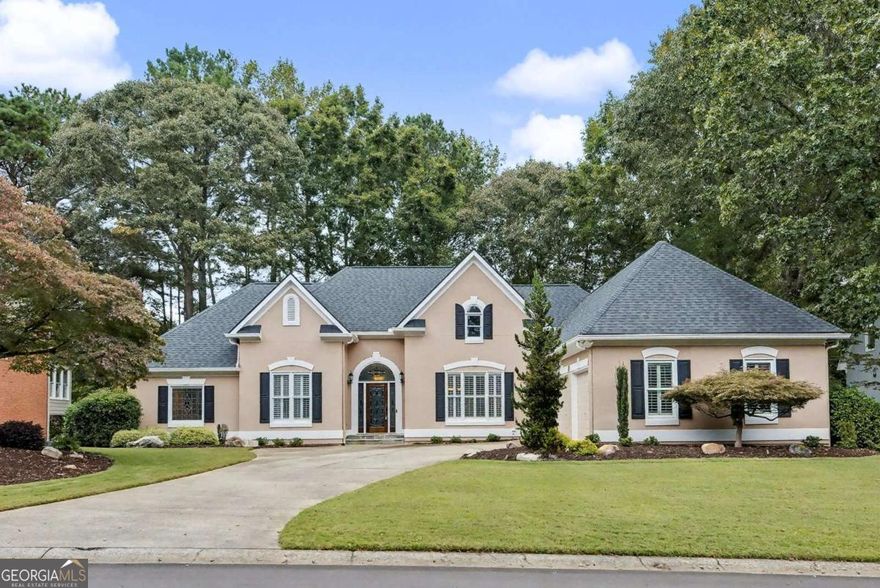 Beautiful ranch on a golf course lot in Towne Lake Hills East, one of Woodstock's premier golf communities! This well-maintained home offers easy main-level living with plantation shutters throughout, vaulted ceilings, and an open, light-filled floor plan. The spacious great room with fireplace opens to the dining area and bright kitchen with a new dishwasher. The primary suite features a tray ceiling, dual walk-in closets, and a spa-like bath. Two additional bedrooms share a jack-and-jill bath. The finished basement includes a large rec room, full bath, and generous storage/workshop space. Relax outdoors on the screened porch, deck, or covered patio overlooking the golf course views and astro-turf backyard. Other highlights include front accent lighting, full irrigation capability, a 3-car garage, and a new thermostat. Enjoy Towne Lake Hills East amenities-golf, swim, tennis, clubhouse-and proximity to downtown Woodstock, shopping, and top schools!